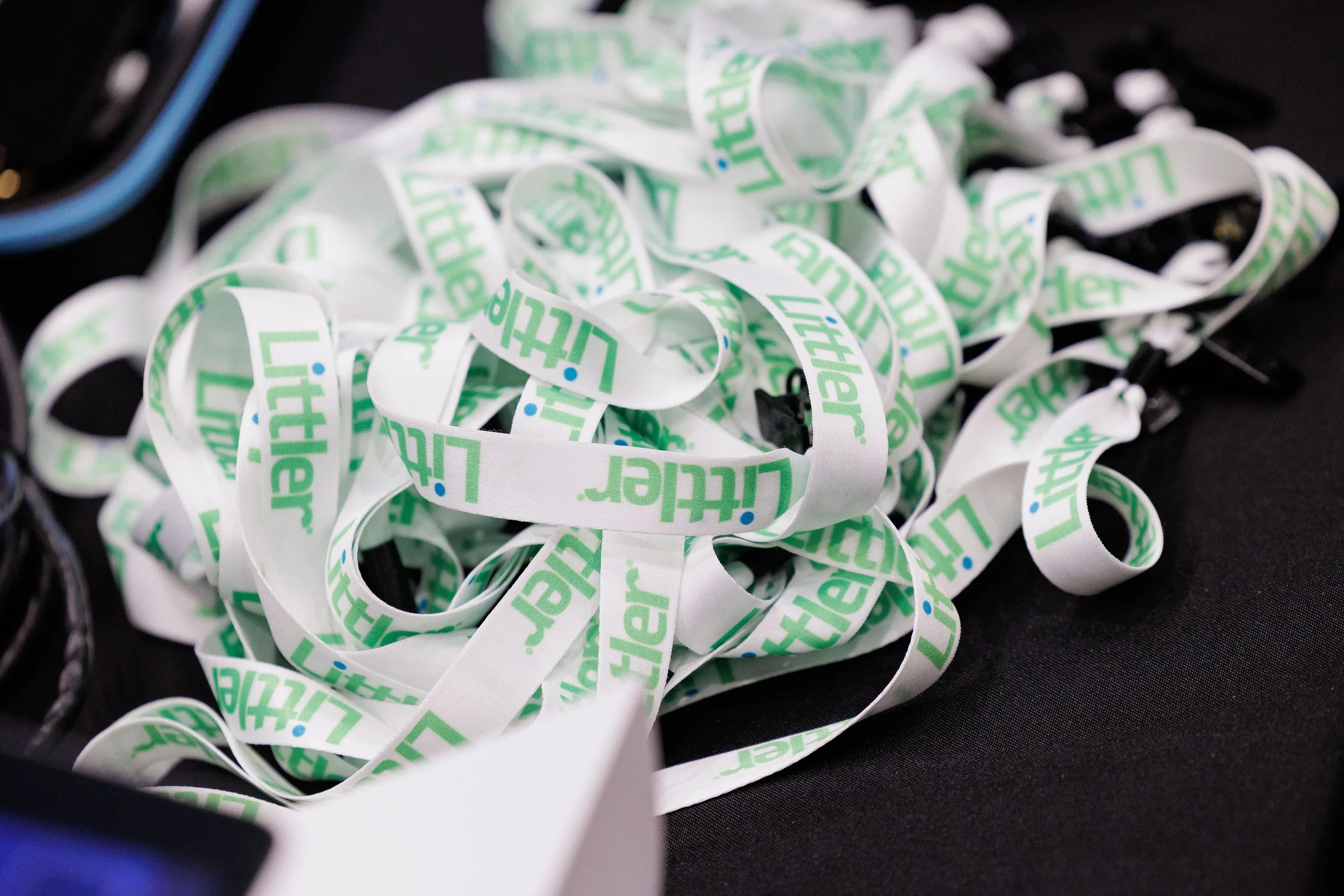 Pile of branded lanyards on registration table at Orlando corporate conference event