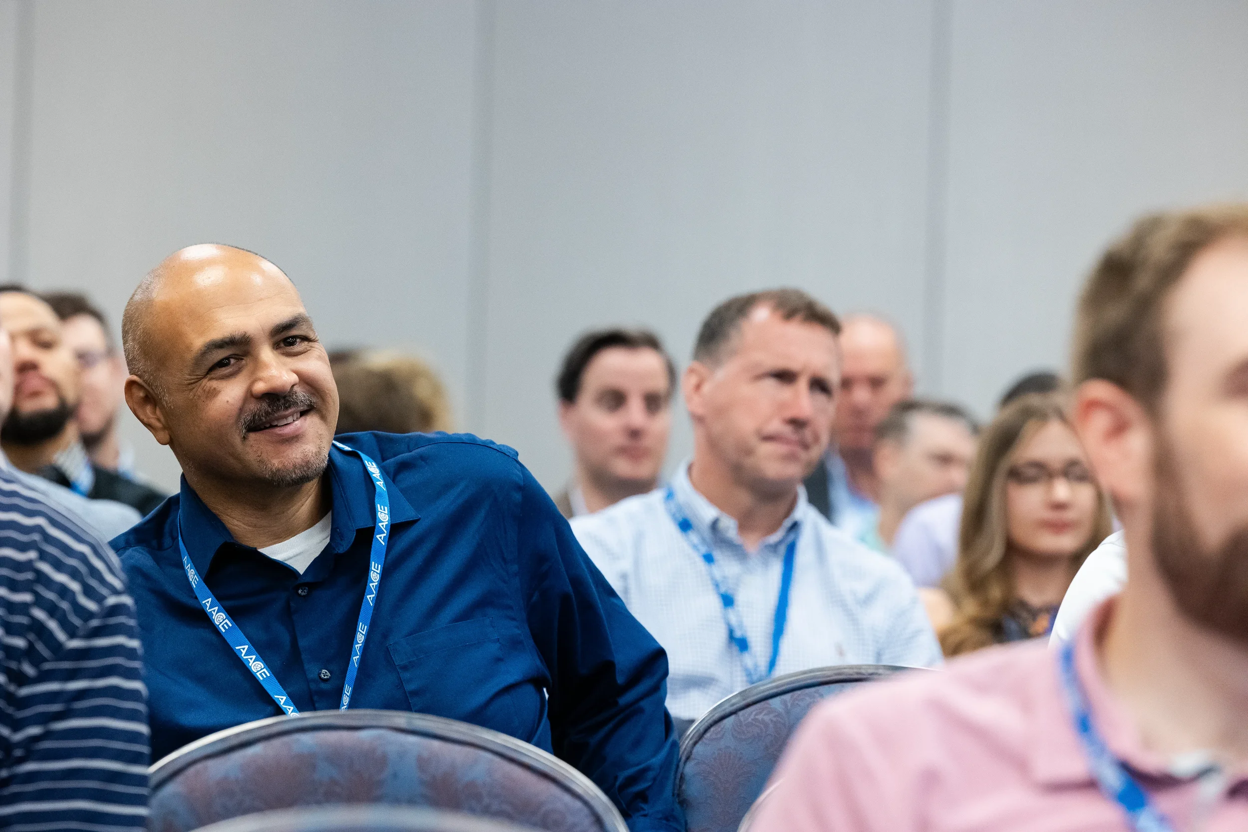 Conference attendee smiles during breakout session at Chicago corporate event