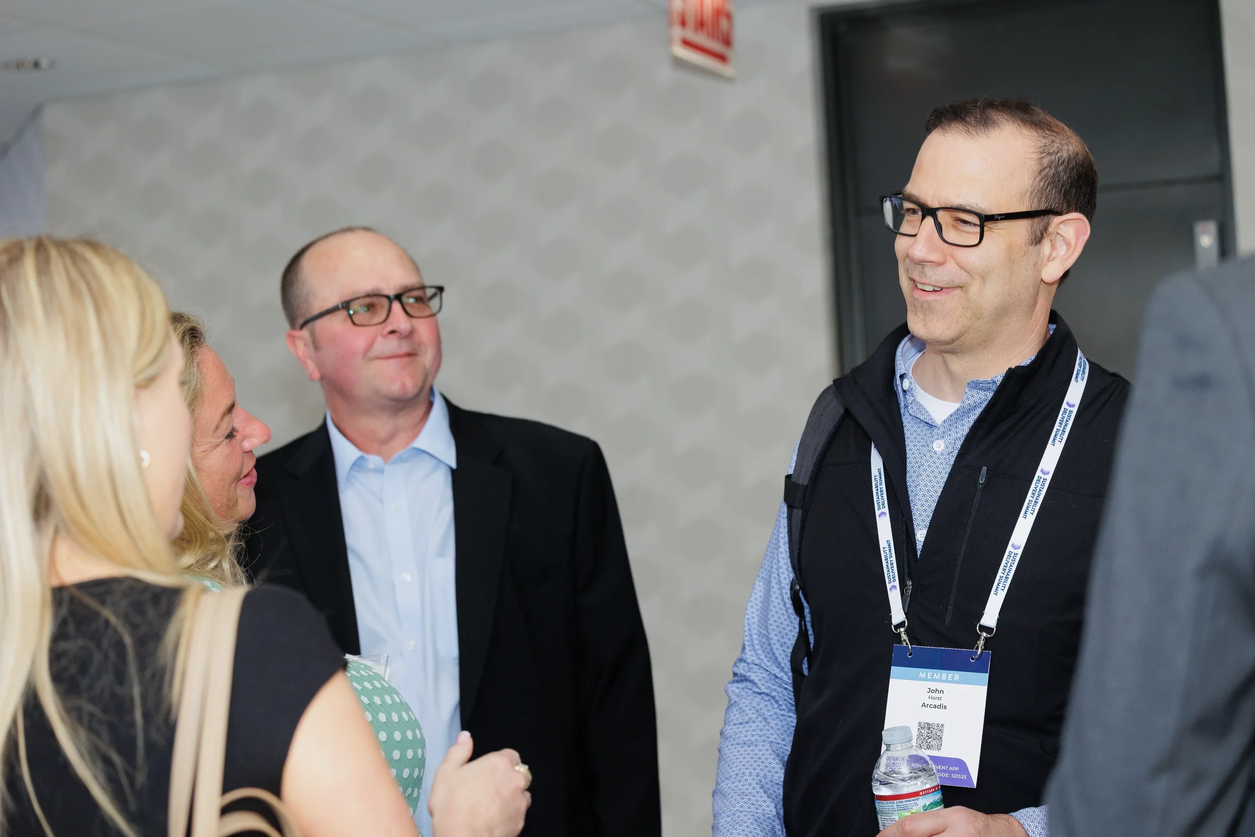 Group of attendees converse together during networking break at Orlando industry conference