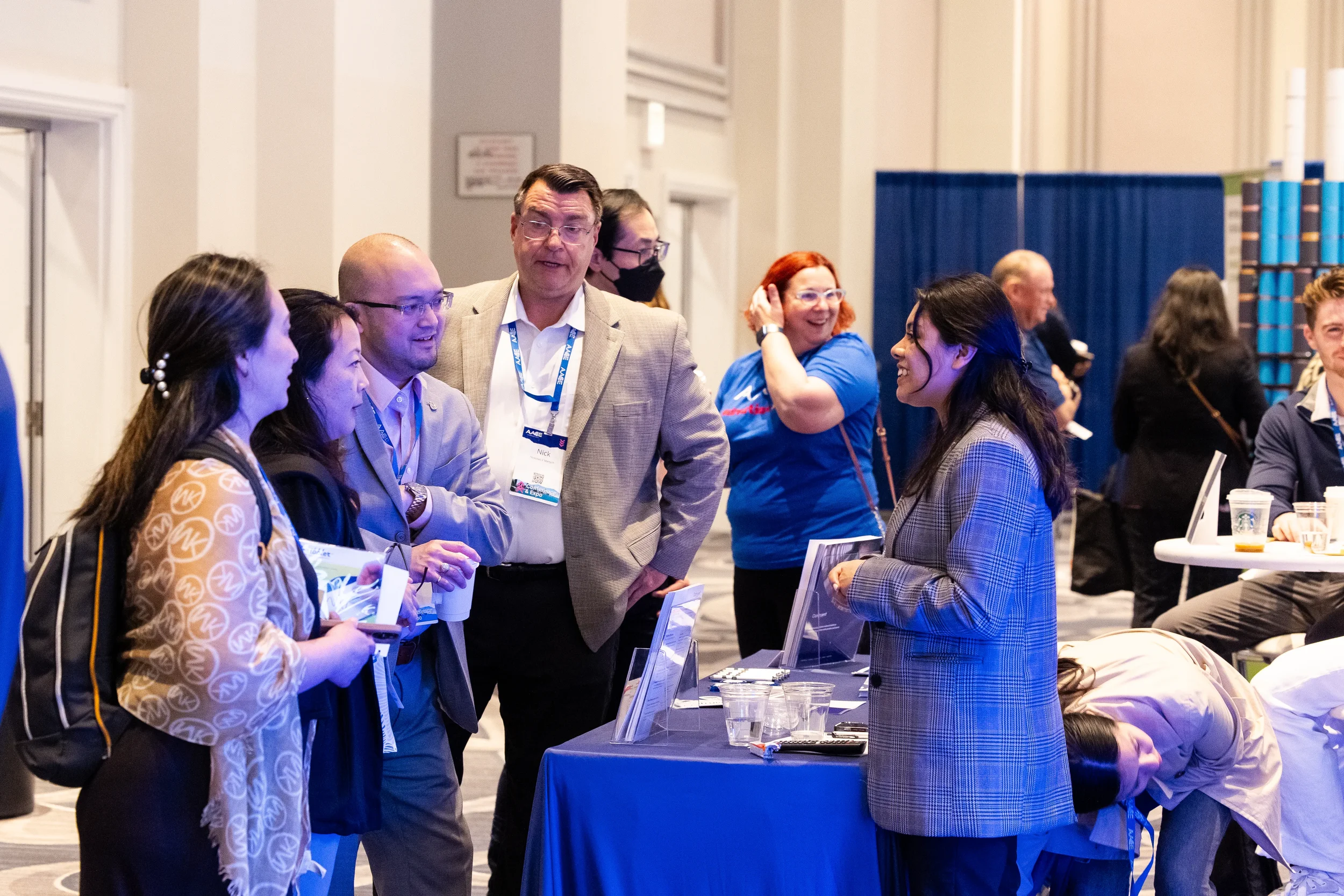 Conference attendees gathering at registration table during Chicago trade show