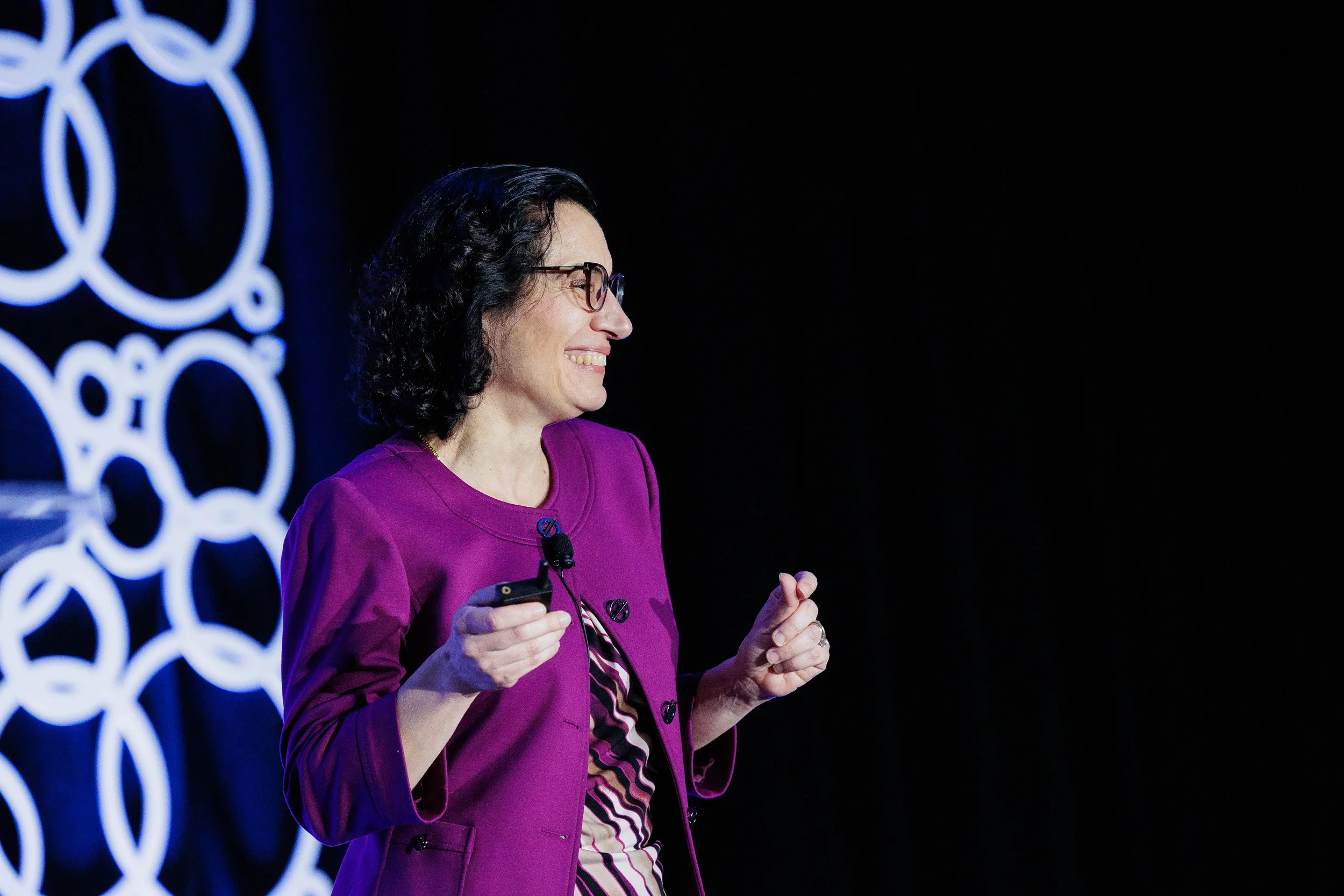 Speaker gestures while presenting on stage at Orlando corporate conference general session