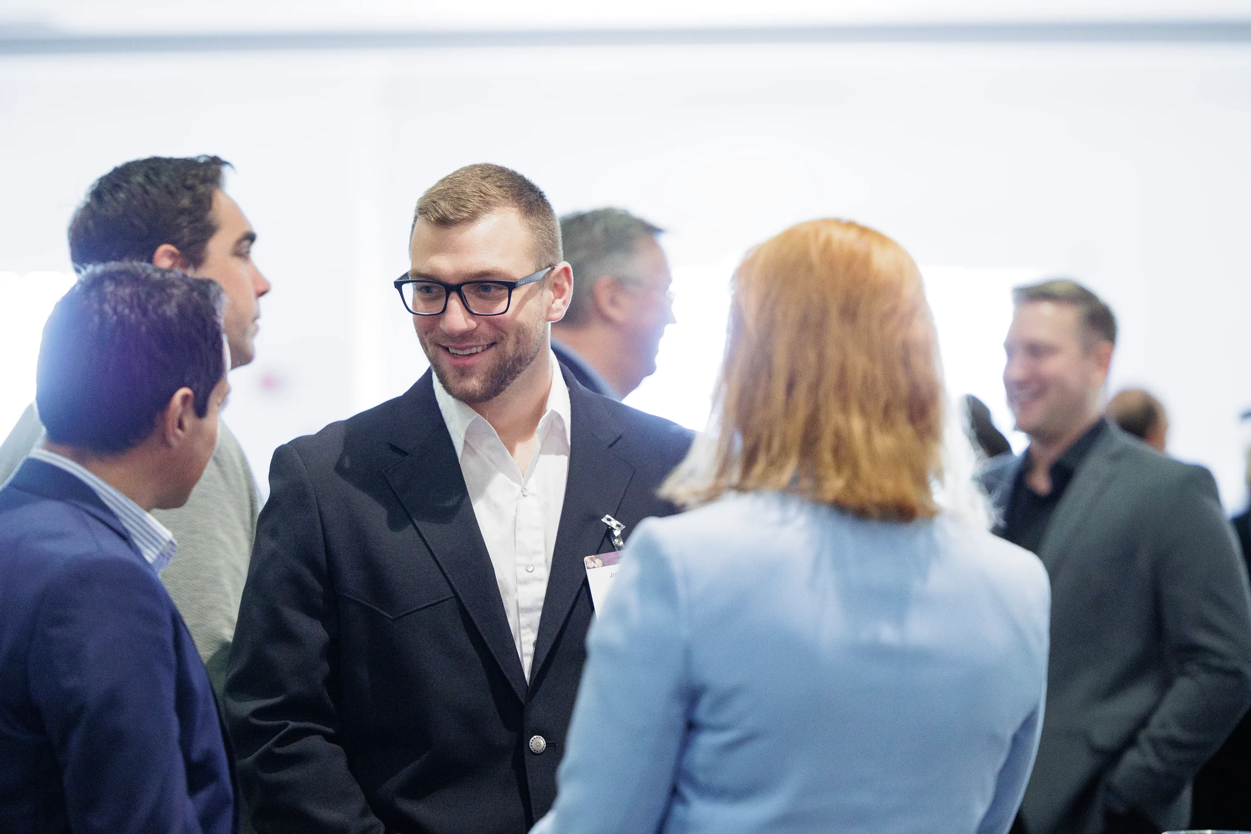 Attendee smiles during conversation on expo floor at Chicago corporate conference