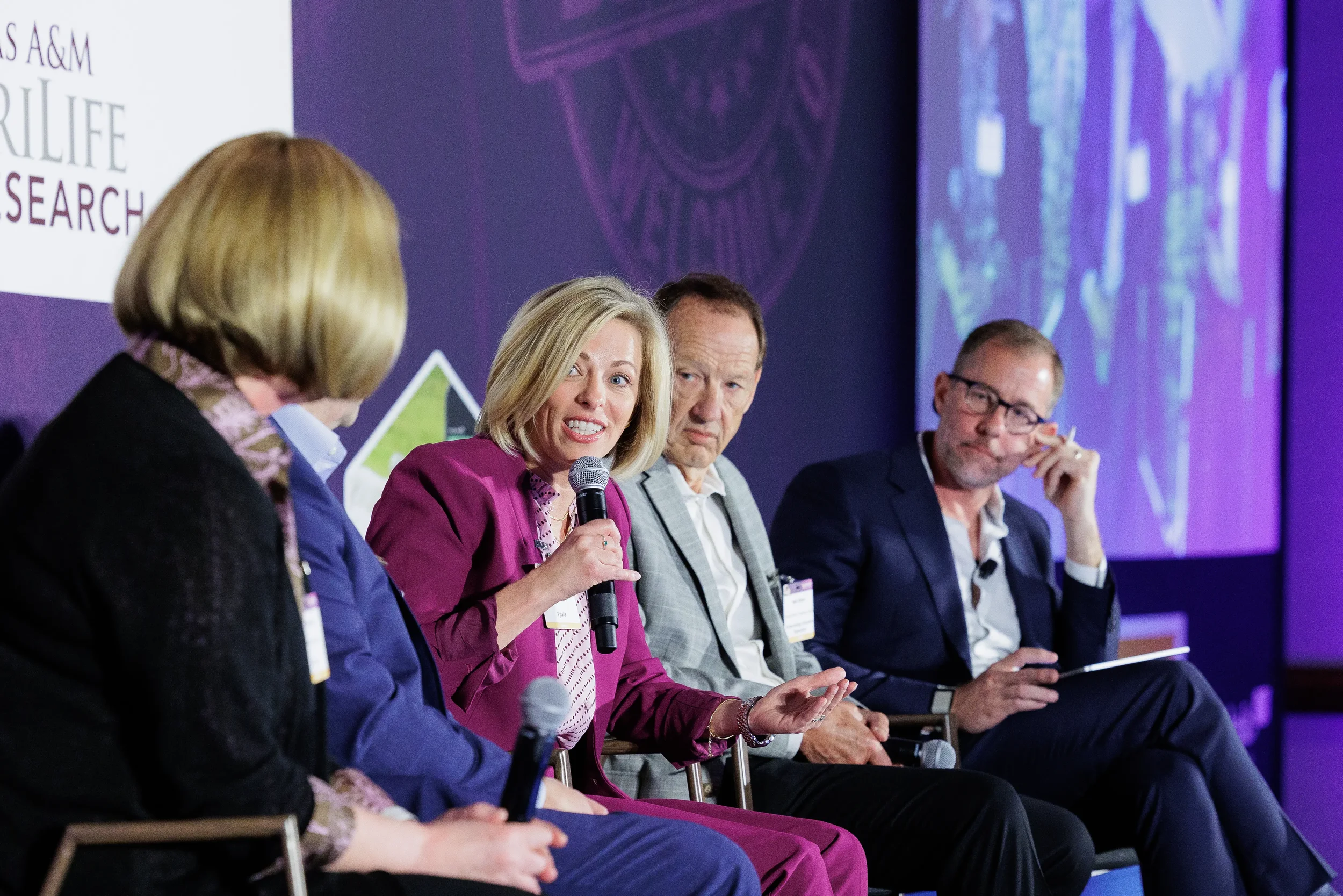 Panelist speaks into microphone during seated discussion at Chicago industry summit