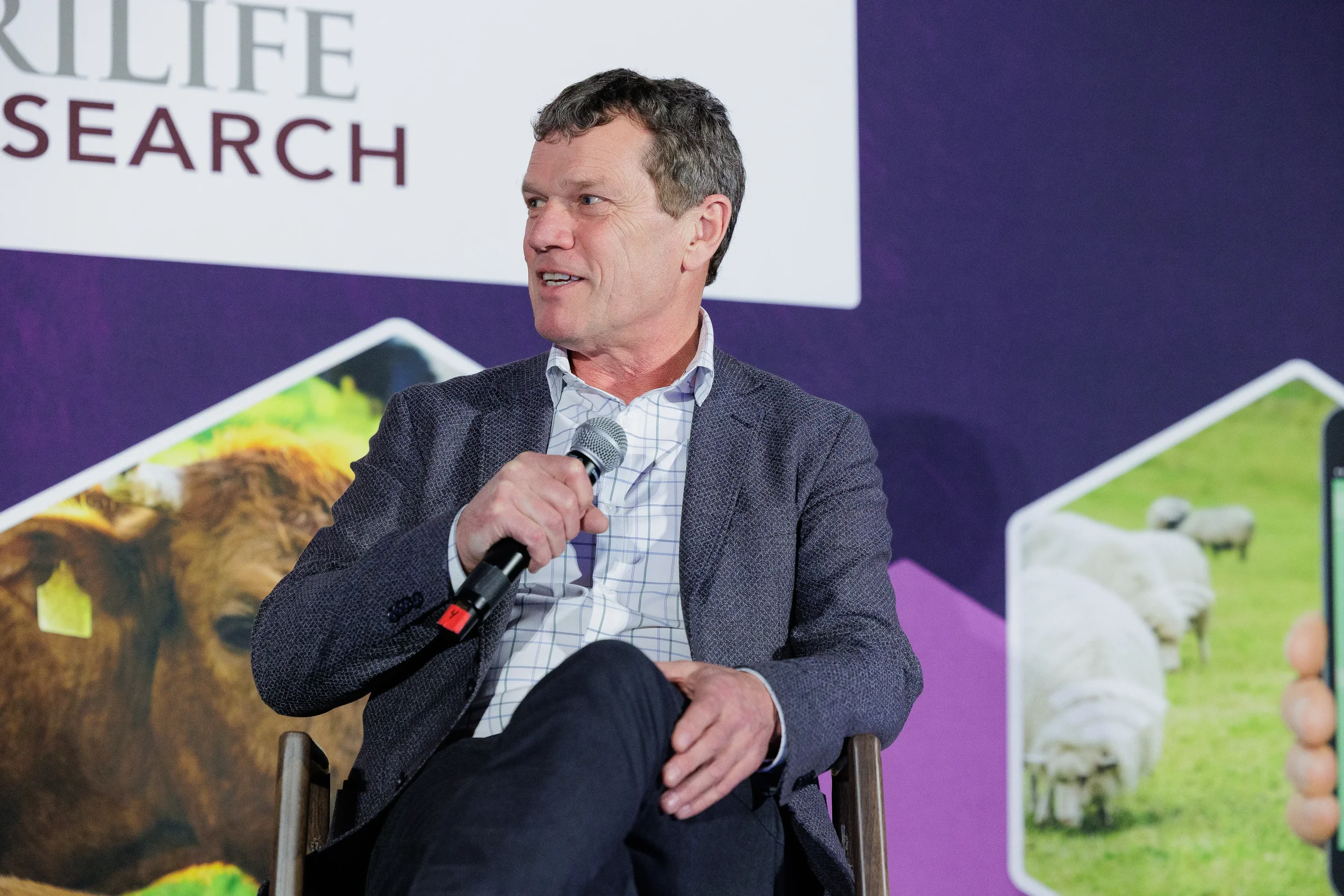 Panelist speaks into microphone during seated discussion at Orlando industry conference