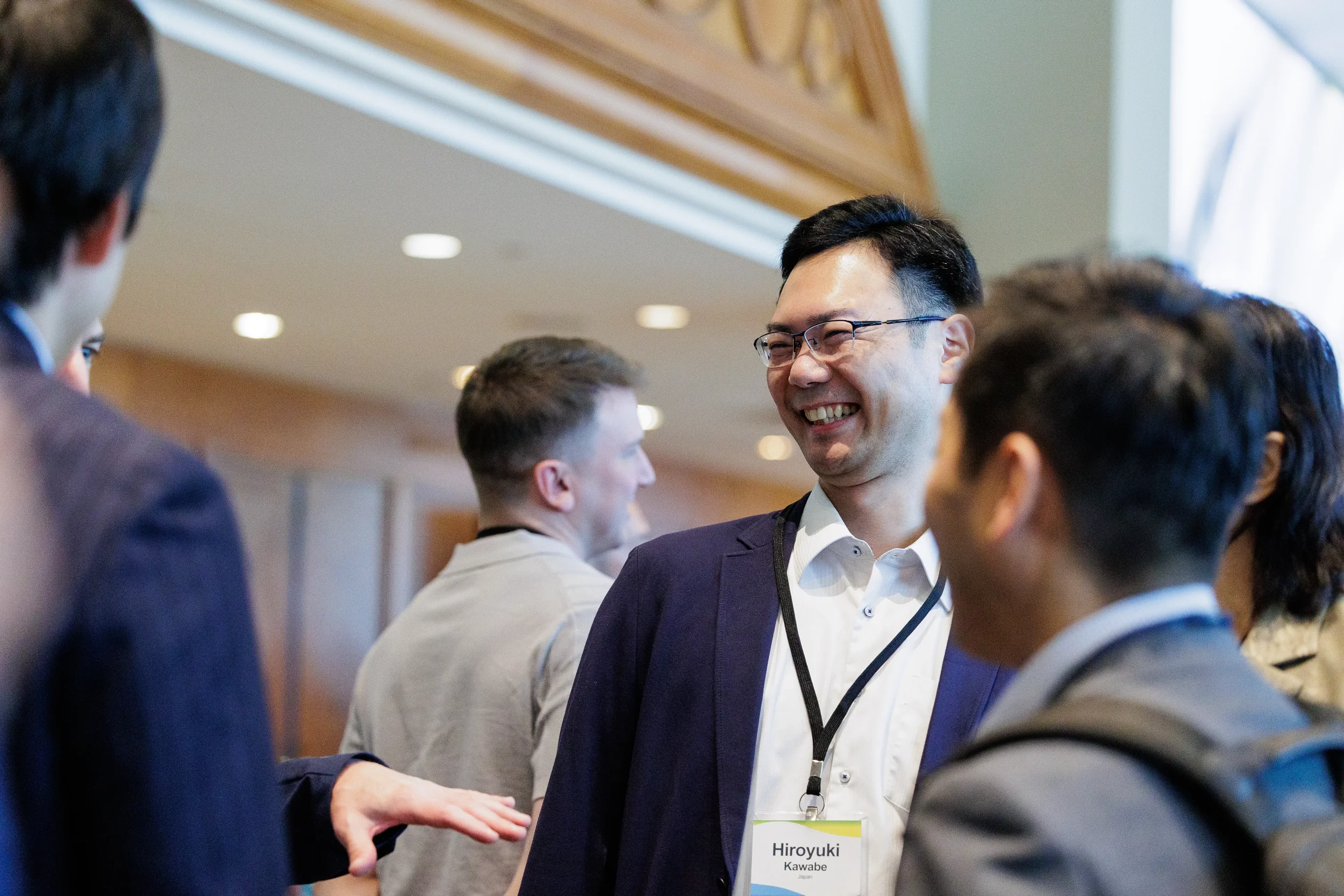 Attendee laughs during conversation with colleagues at Chicago industry conference