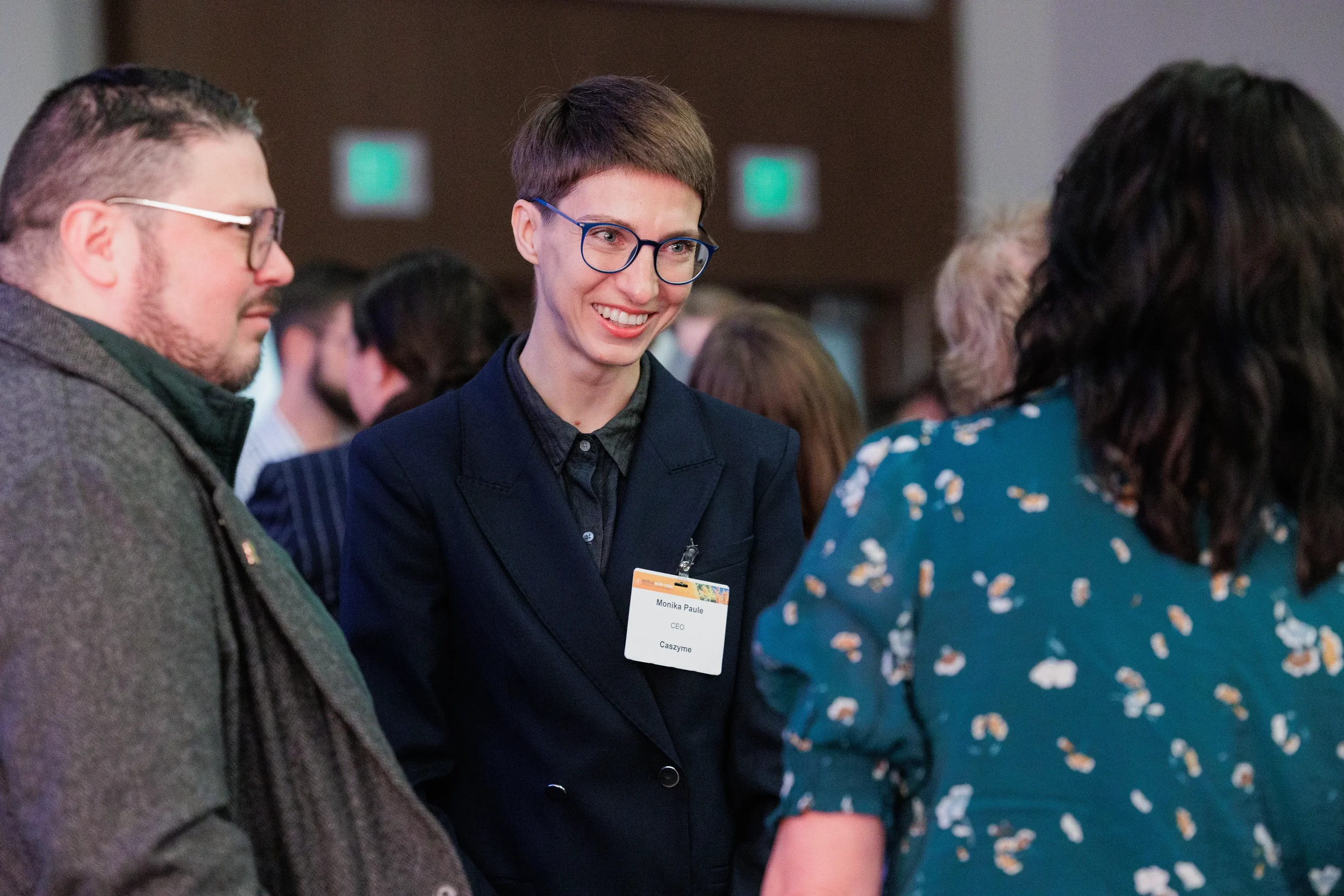 Attendee smiles while networking with colleagues at Chicago corporate conference reception