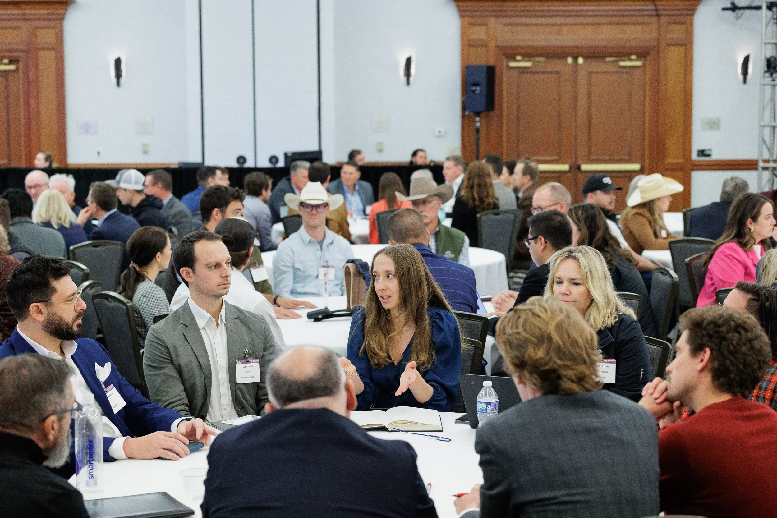Attendees engage in roundtable discussion in crowded ballroom at Chicago industry conference