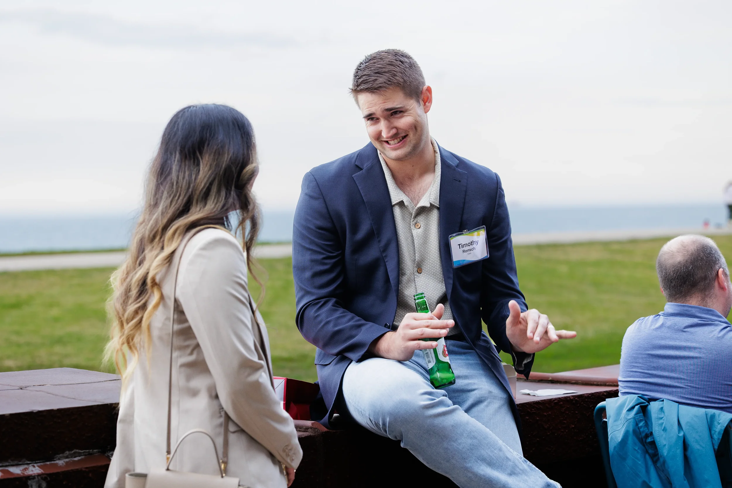 Attendees converse outdoors during lakefront reception at Orlando networking event