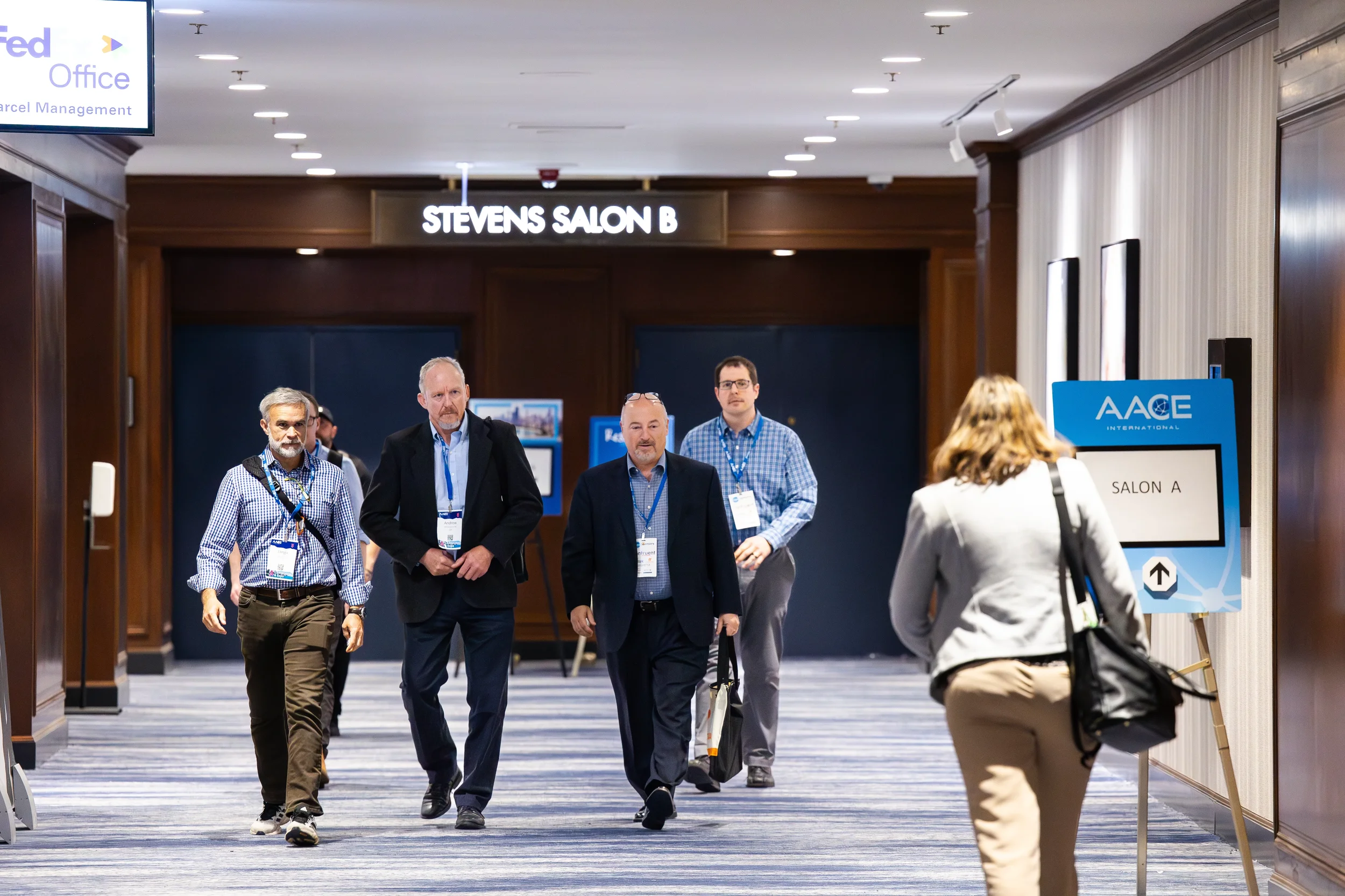 Conference attendees walk through hotel hallway toward sessions at AACE International 2024 in Orlando