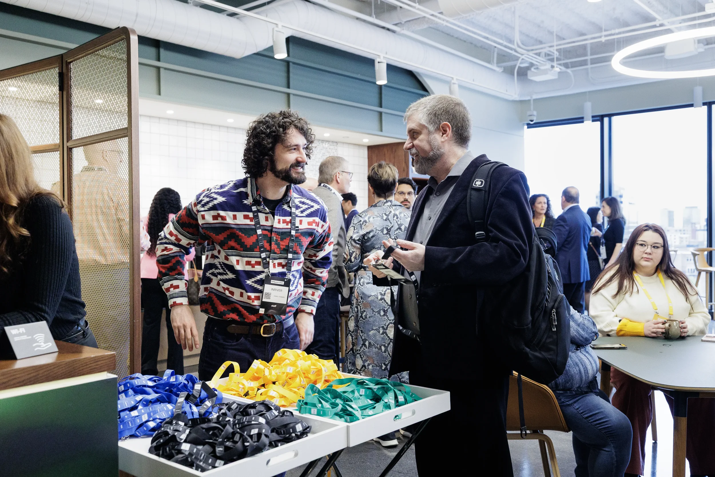 Attendees chat at registration table with colorful lanyards during Chicago corporate event check-in