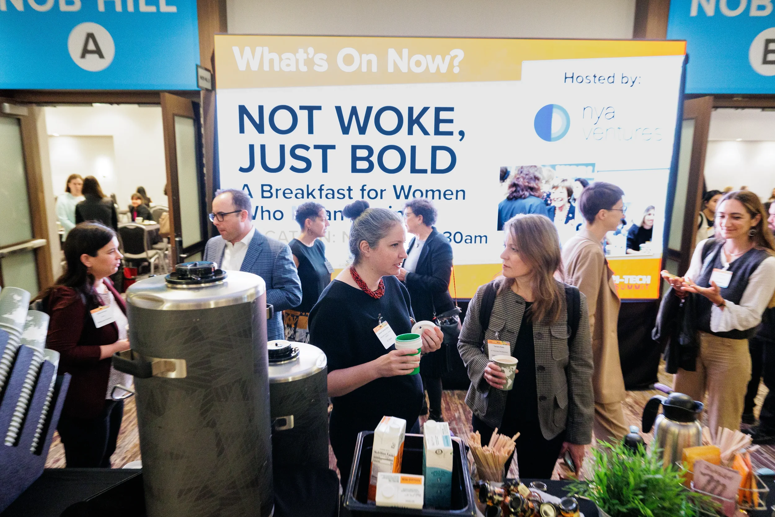 Attendees converse over coffee during networking break at Orlando corporate conference event