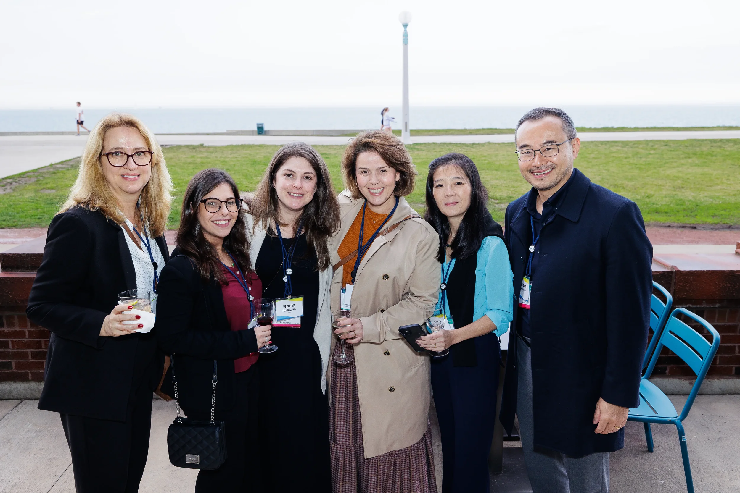 Group of attendees pose together along the lakefront at Chicago corporate event