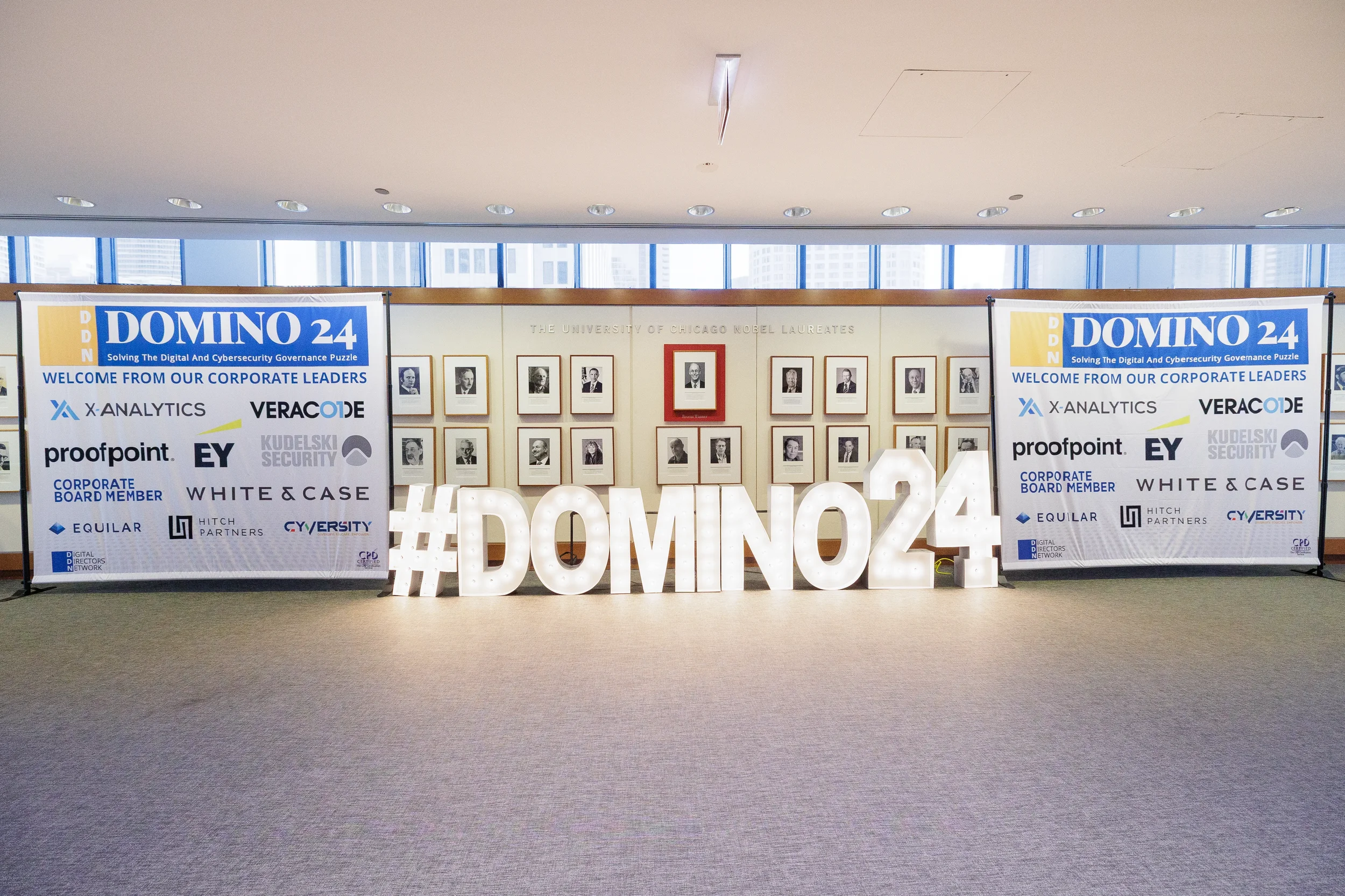 Illuminated hashtag sign flanked by sponsor banners in lobby at Chicago corporate conference