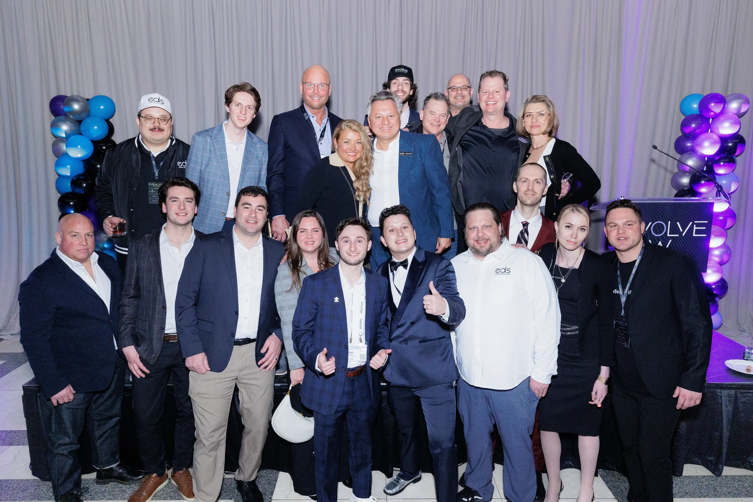 Large group of staff and attendees pose for photo on stage at Chicago corporate event