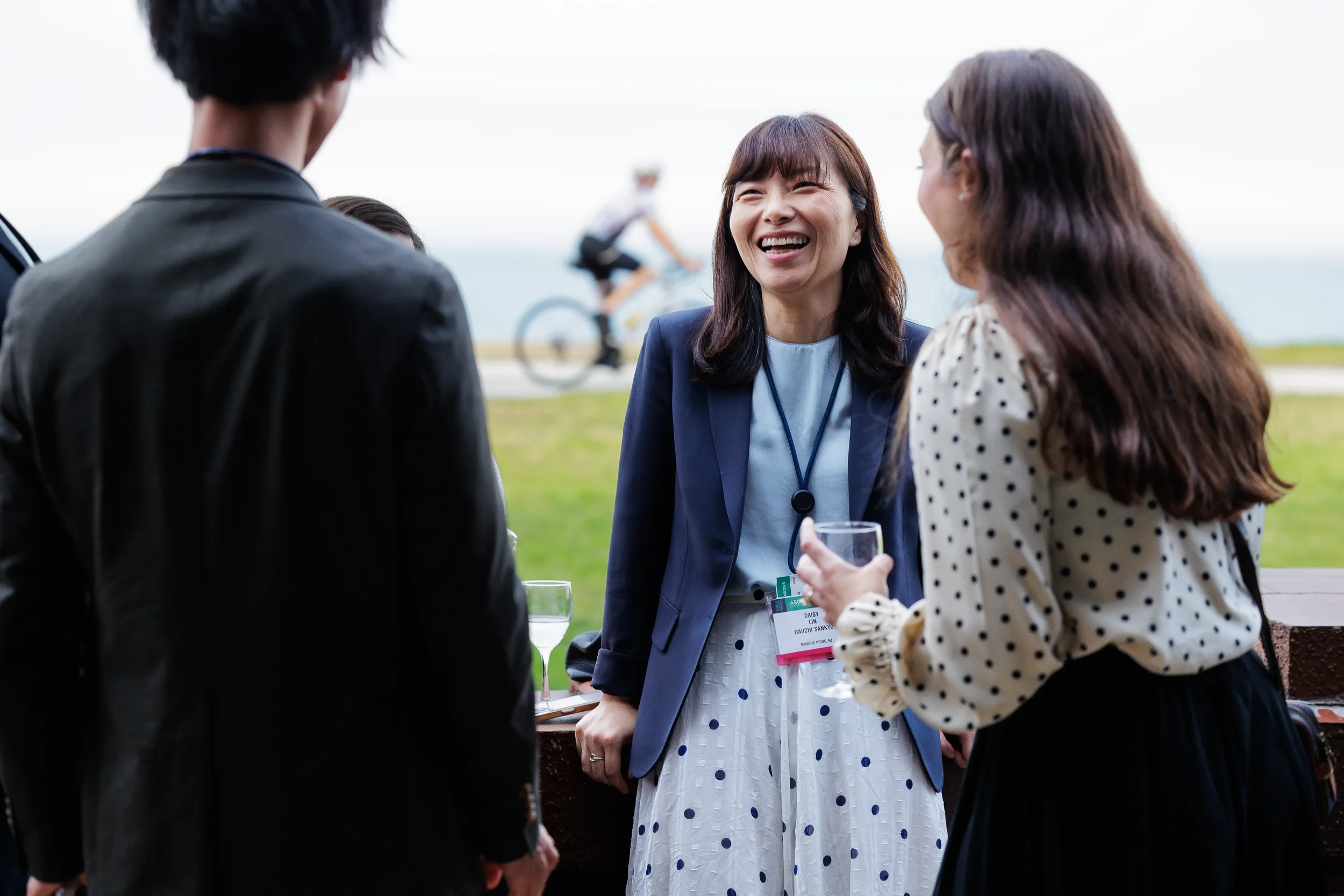 Attendee laughs while chatting with colleagues at outdoor networking reception for Orlando corporate event