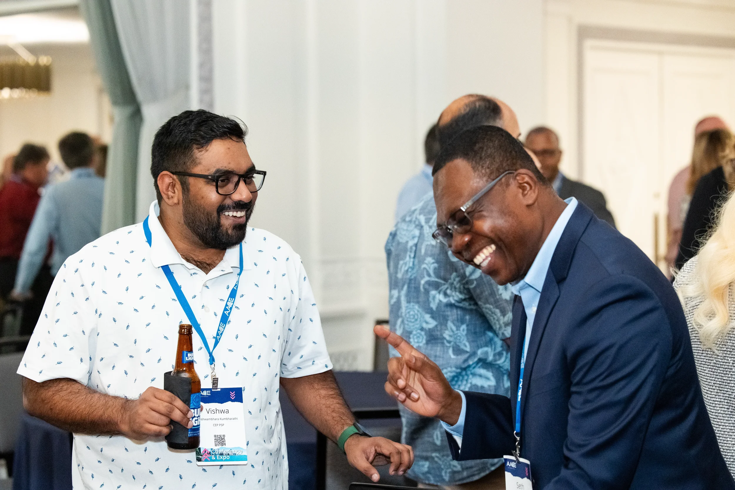 Professionals network and laugh during AACE International reception in Orlando.