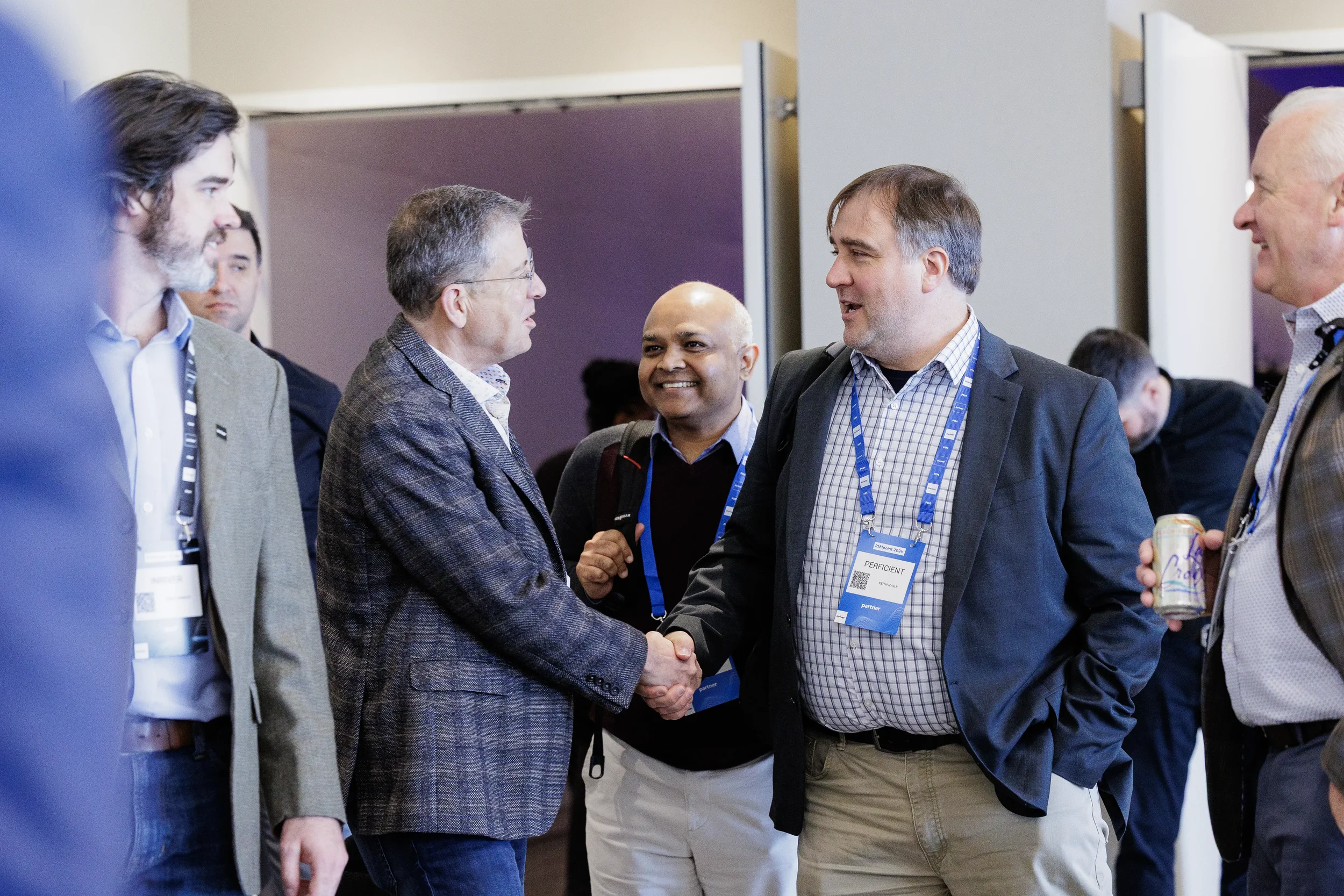 Attendees shake hands and greet each other during networking at Orlando corporate conference