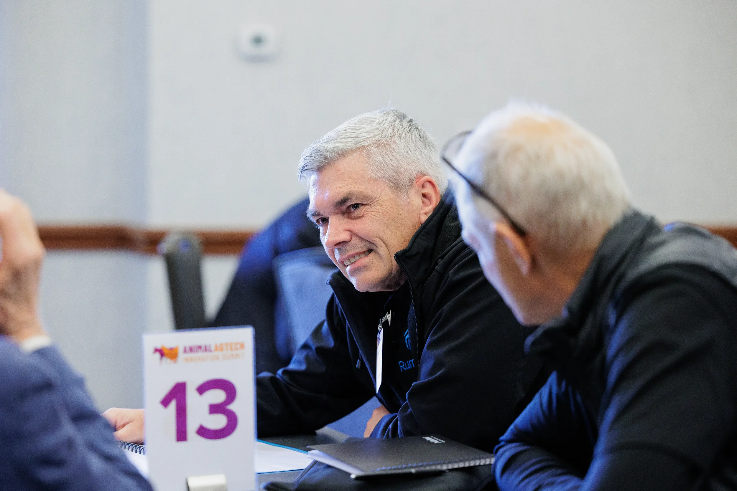 Two attendees converse at networking roundtable during Chicago corporate conference