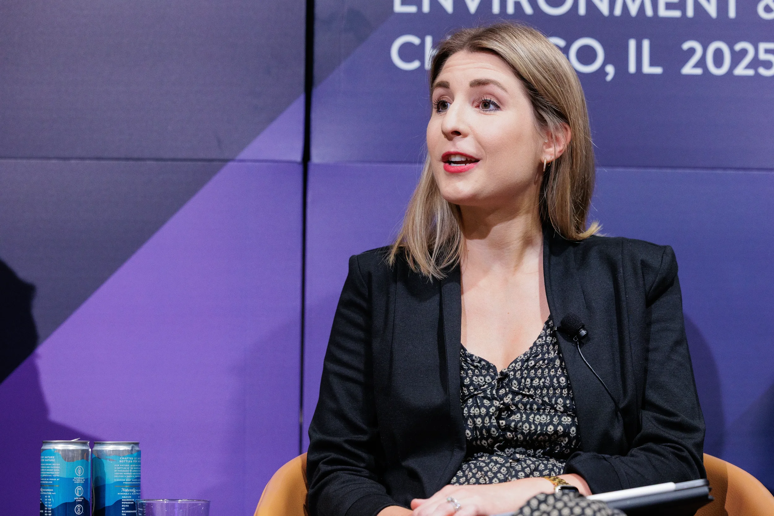 Panelist speaks into microphone during seated discussion at Chicago industry conference