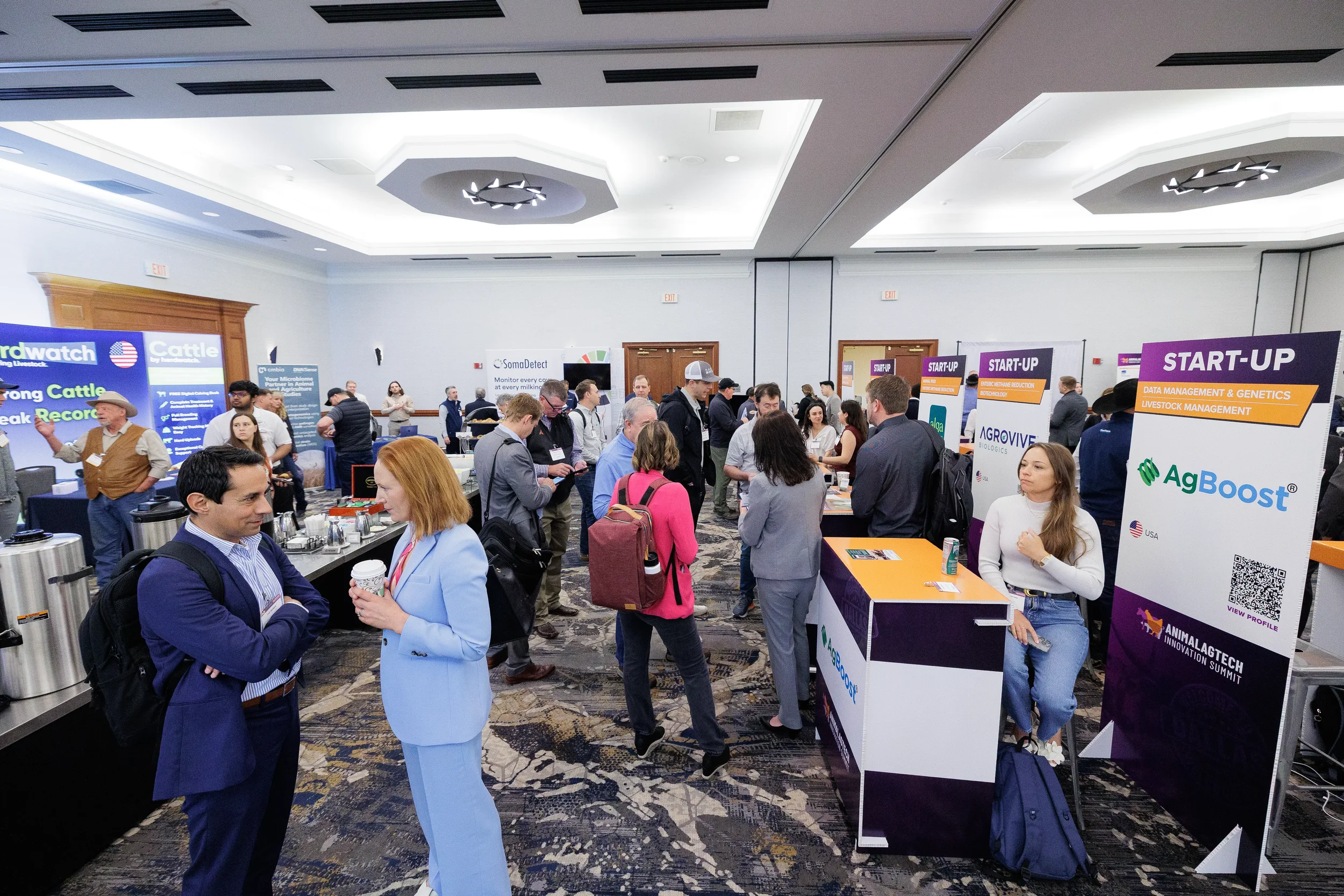 Attendees browse startup exhibitor booths on crowded expo floor at Orlando industry conference