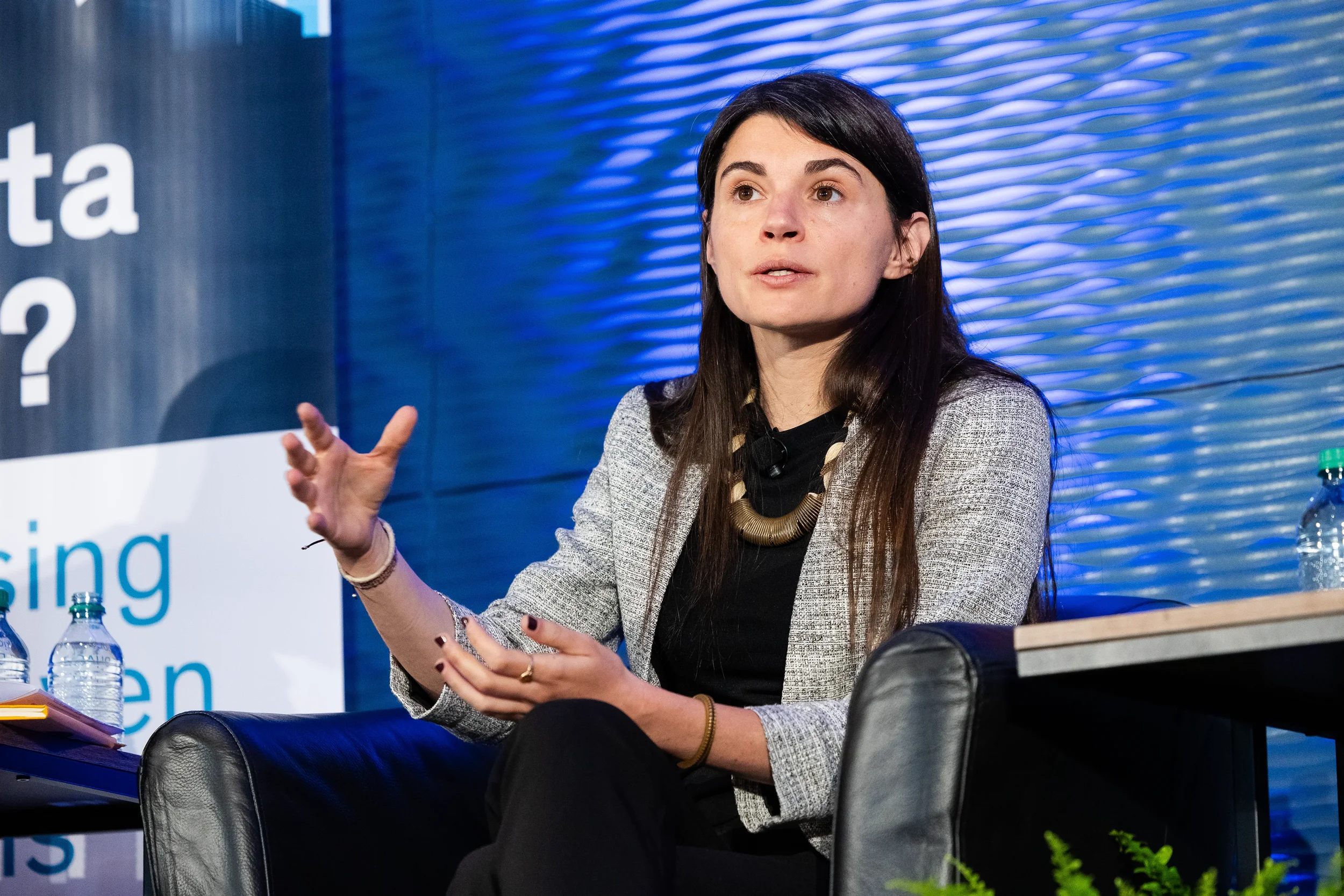 Panelist gestures while speaking during panel discussion on stage at Chicago industry conference