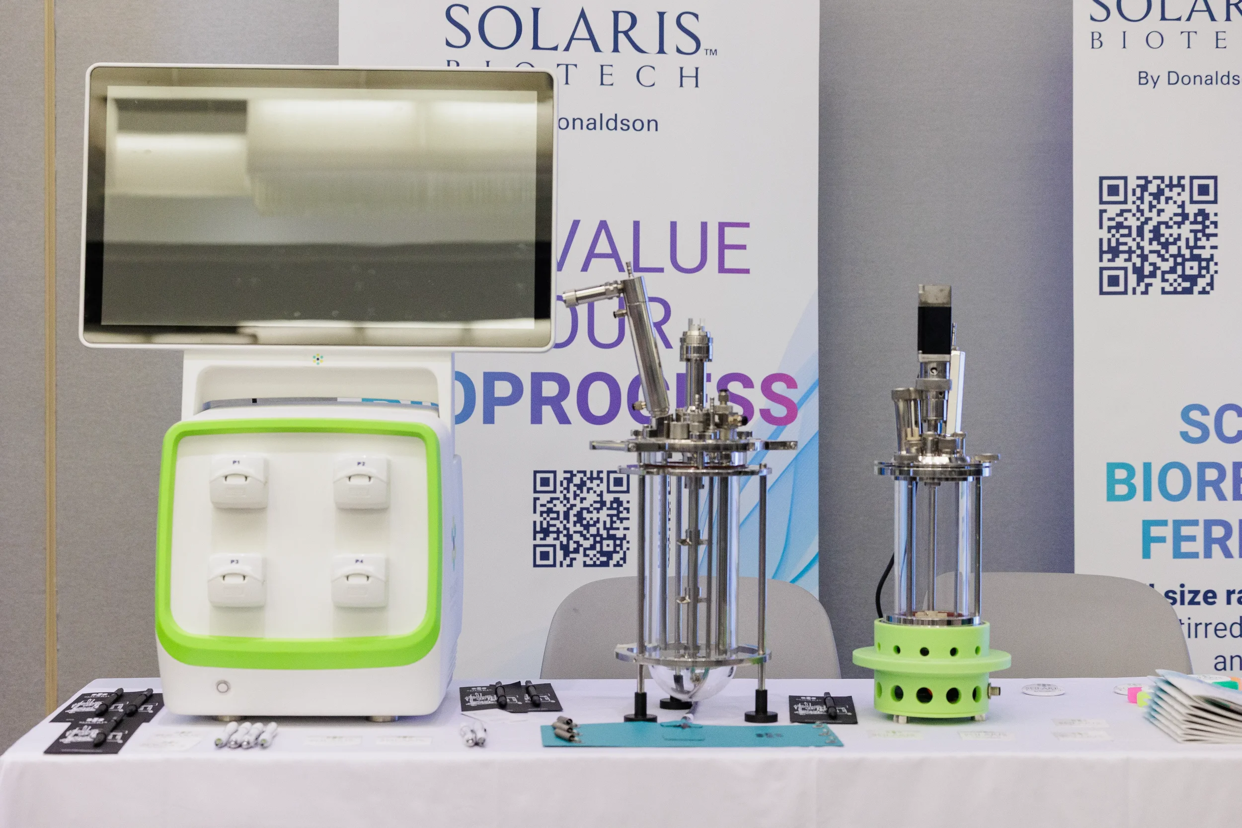 Biotech equipment and devices displayed on table at exhibitor booth during Chicago industry trade show