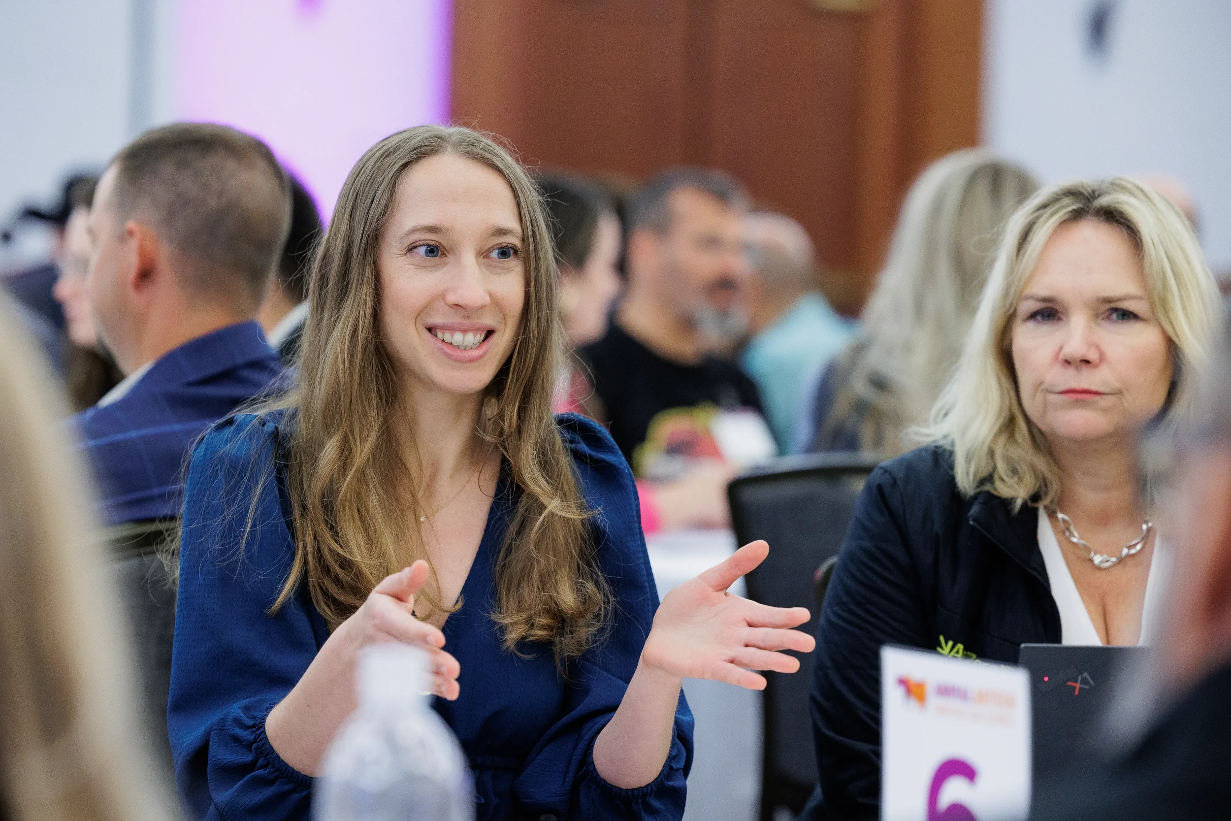 Attendee smiles while networking in conversation at Chicago industry conference