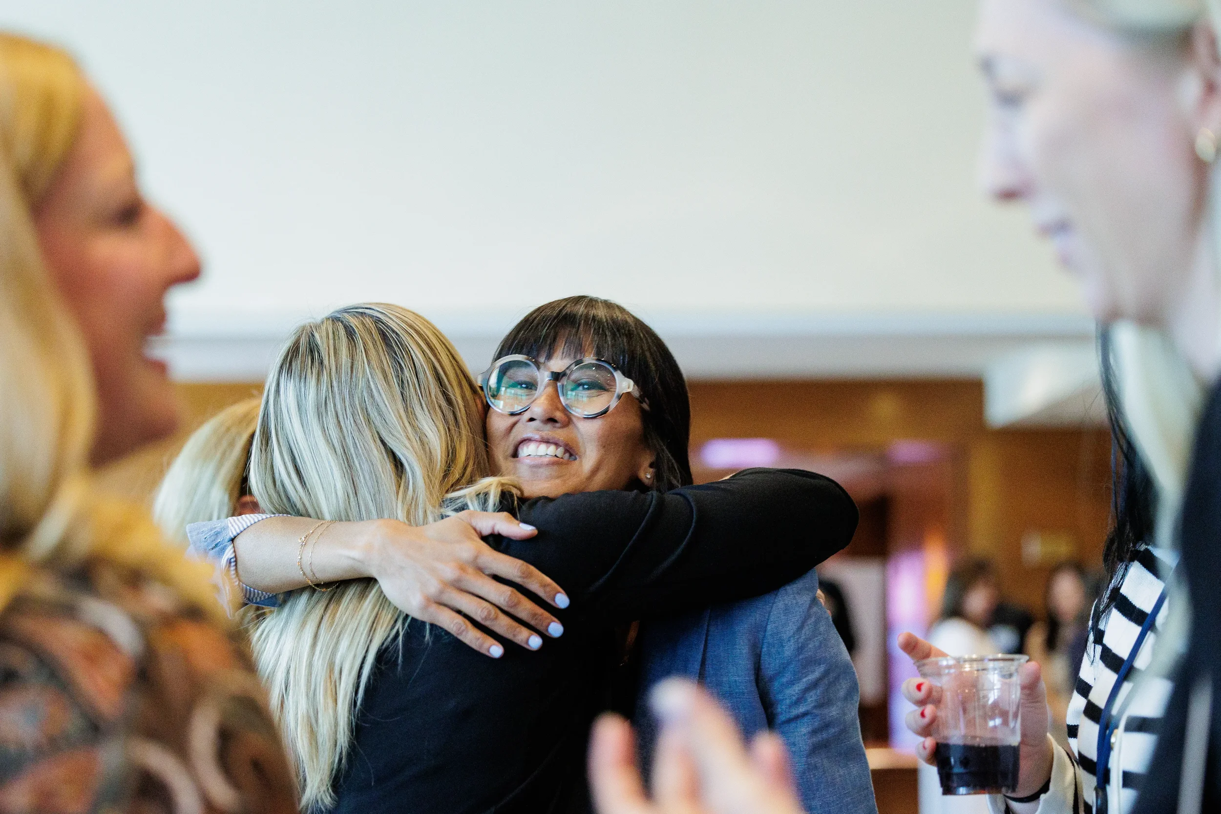 Attendees share a warm embrace during Orlando industry conference reception