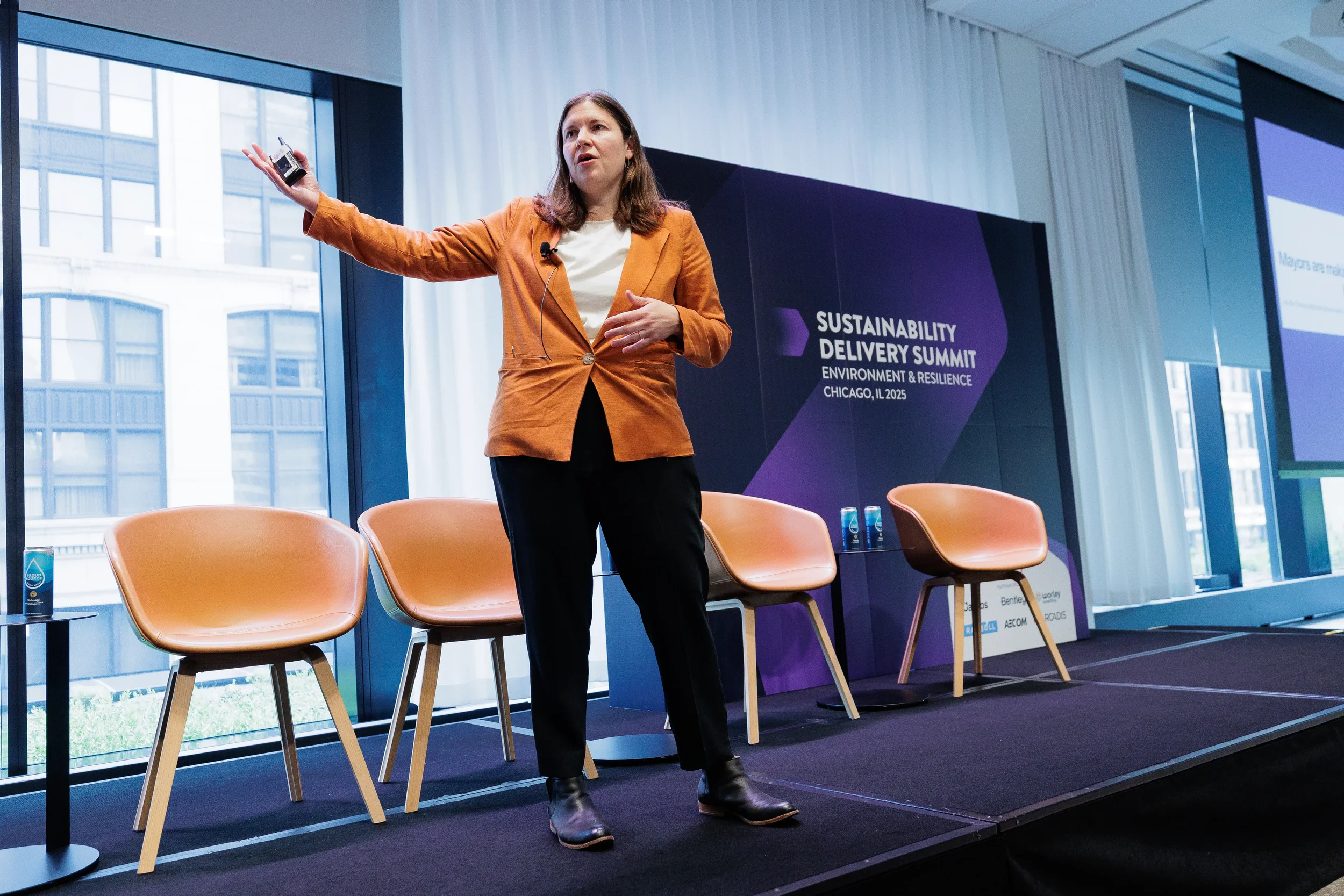 Speaker gestures while presenting on branded stage at Orlando industry summit
