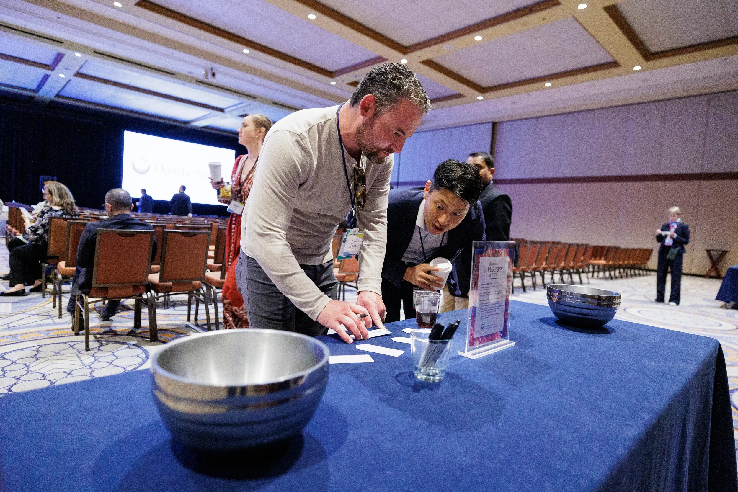 Attendees check items at raffle table during Chicago corporate conference