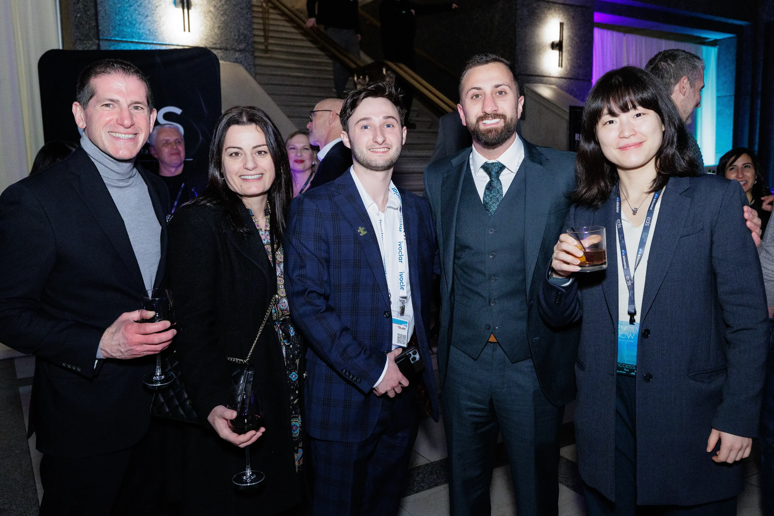 Five attendees pose together with drinks during networking reception at Chicago corporate event