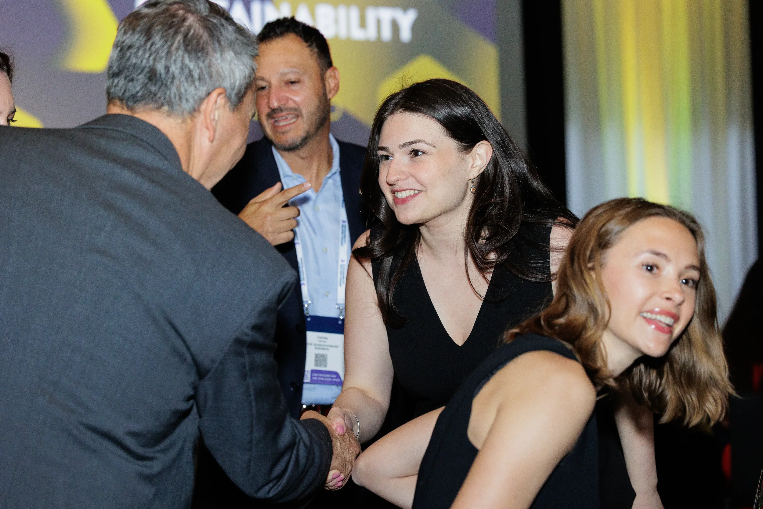 Attendees shake hands and network during reception at Chicago corporate summit