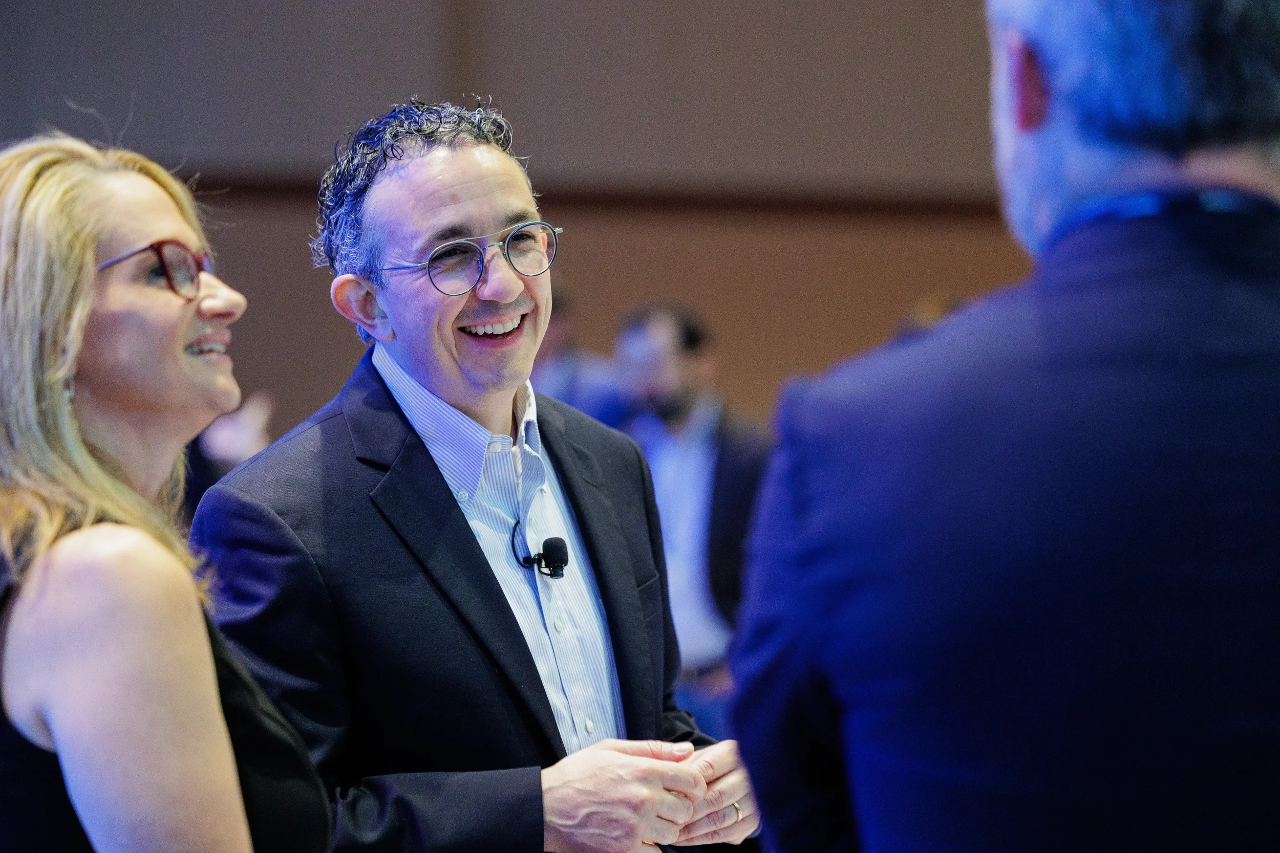 Attendees converse in hallway during break at Chicago corporate conference