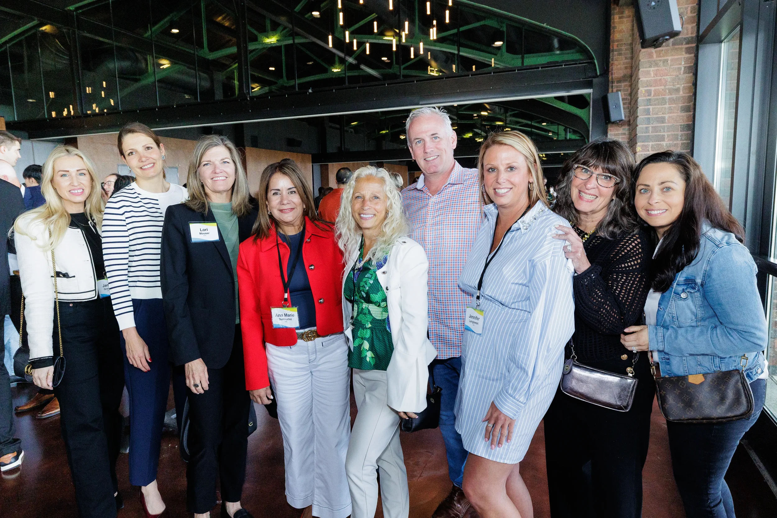Group of attendees pose together during evening reception at Orlando corporate event