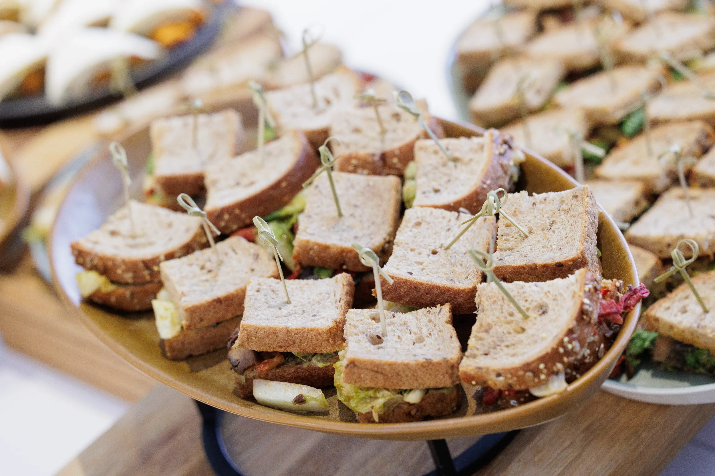 Sandwiches displayed on platter with toothpicks during Chicago corporate event reception