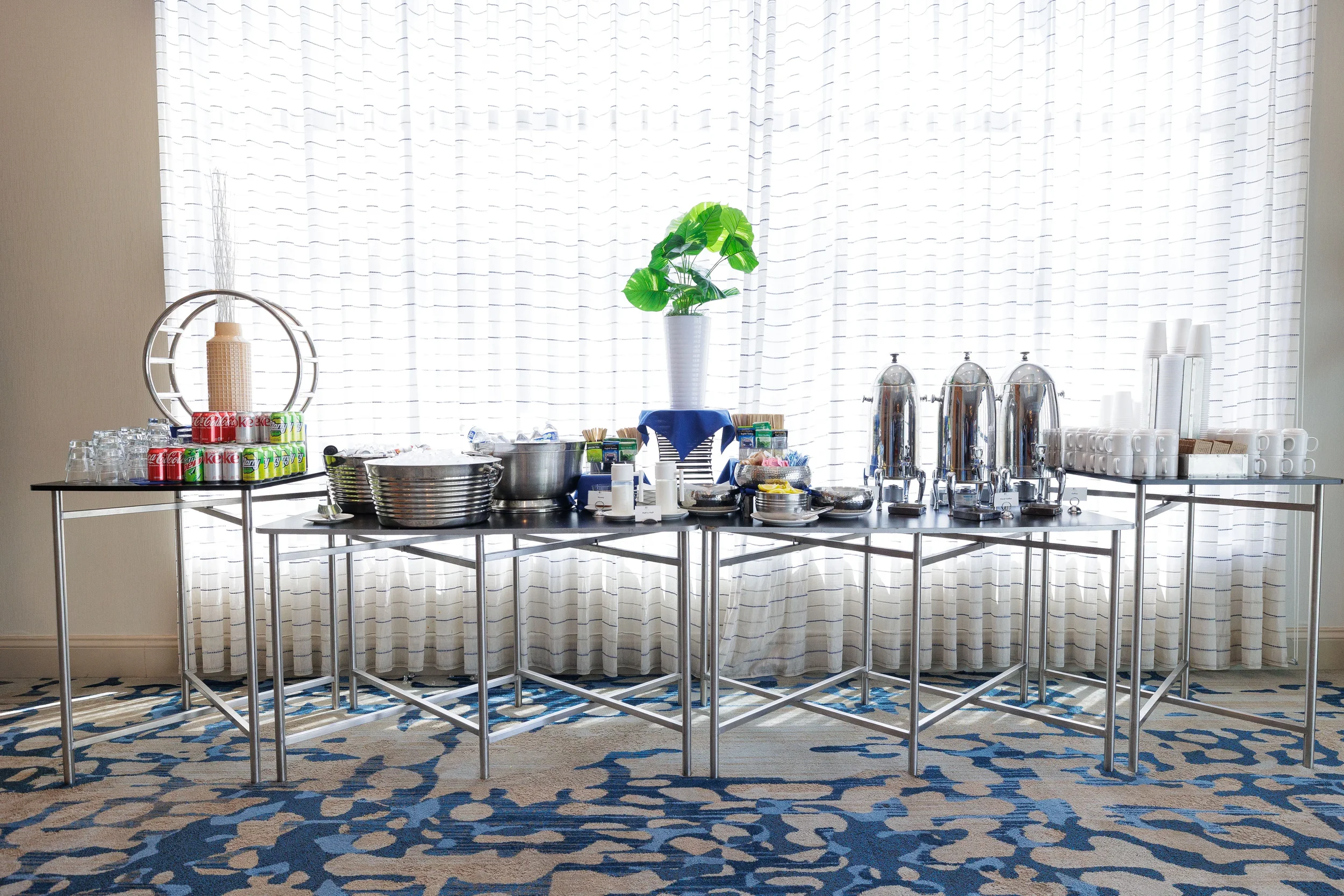 Beverage station with coffee urns, sodas, and glassware set up for Chicago industry conference break