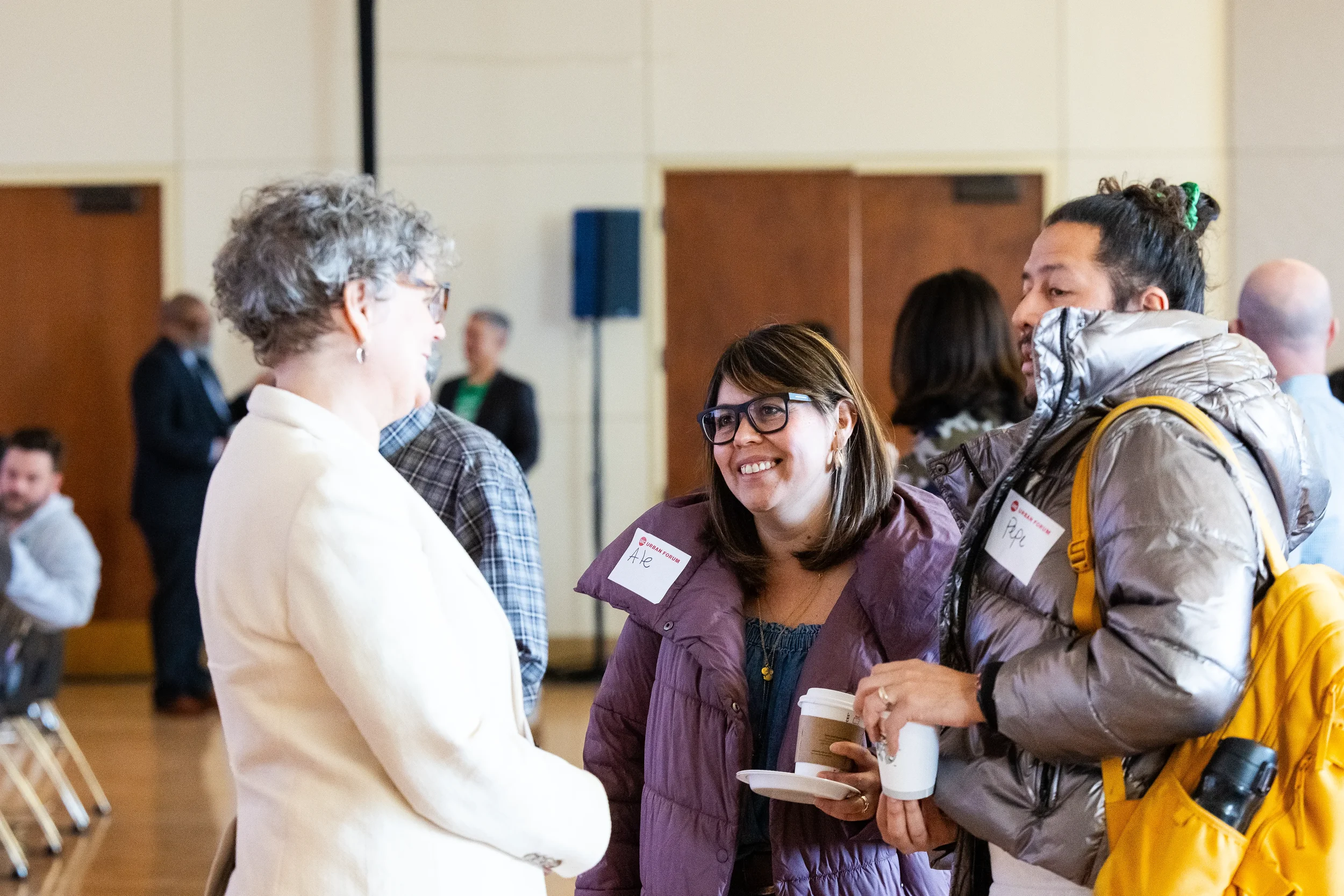Group of attendees converse over coffee during reception at Orlando corporate event