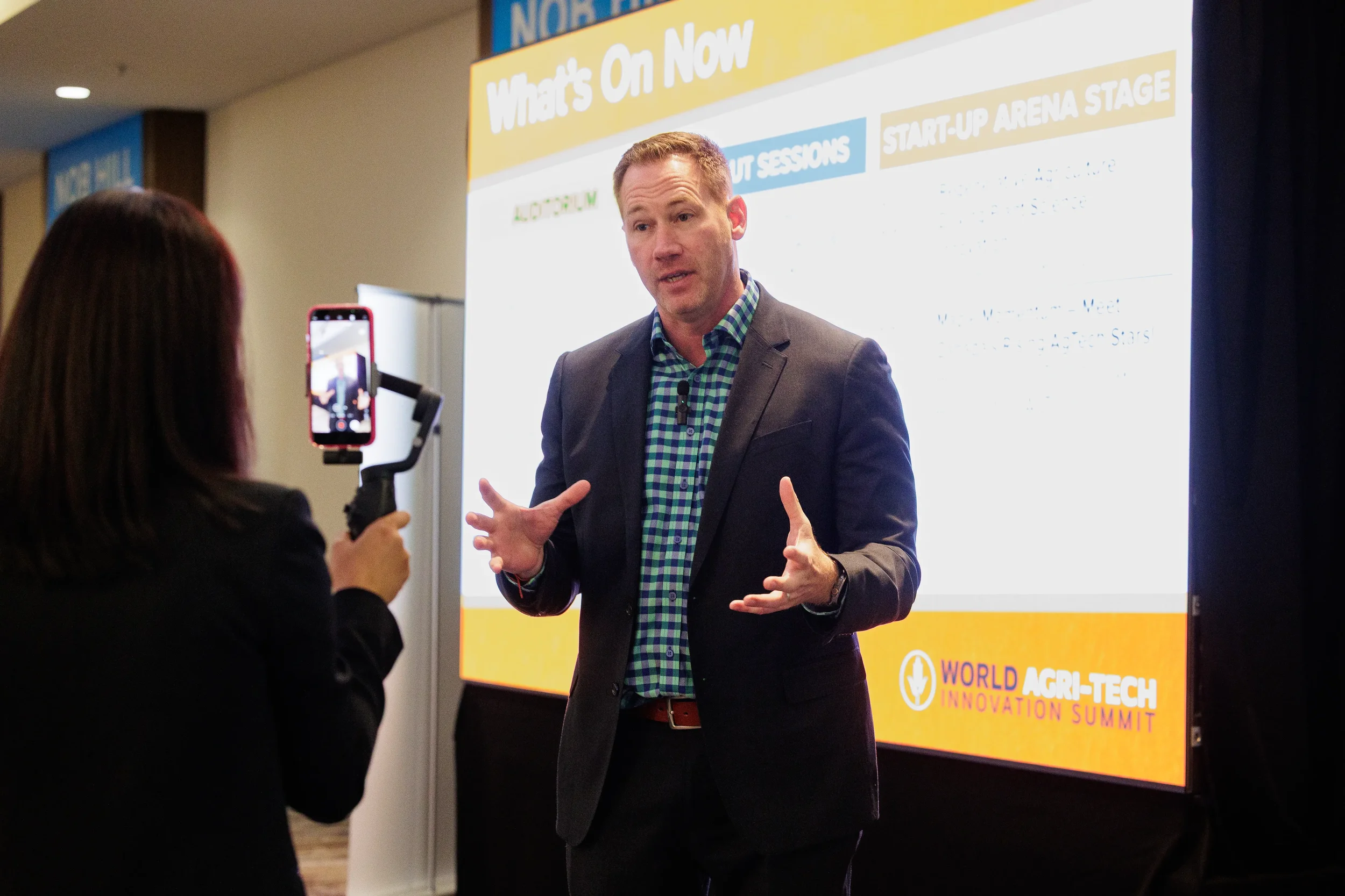 Speaker gestures while being interviewed on video at Orlando industry conference