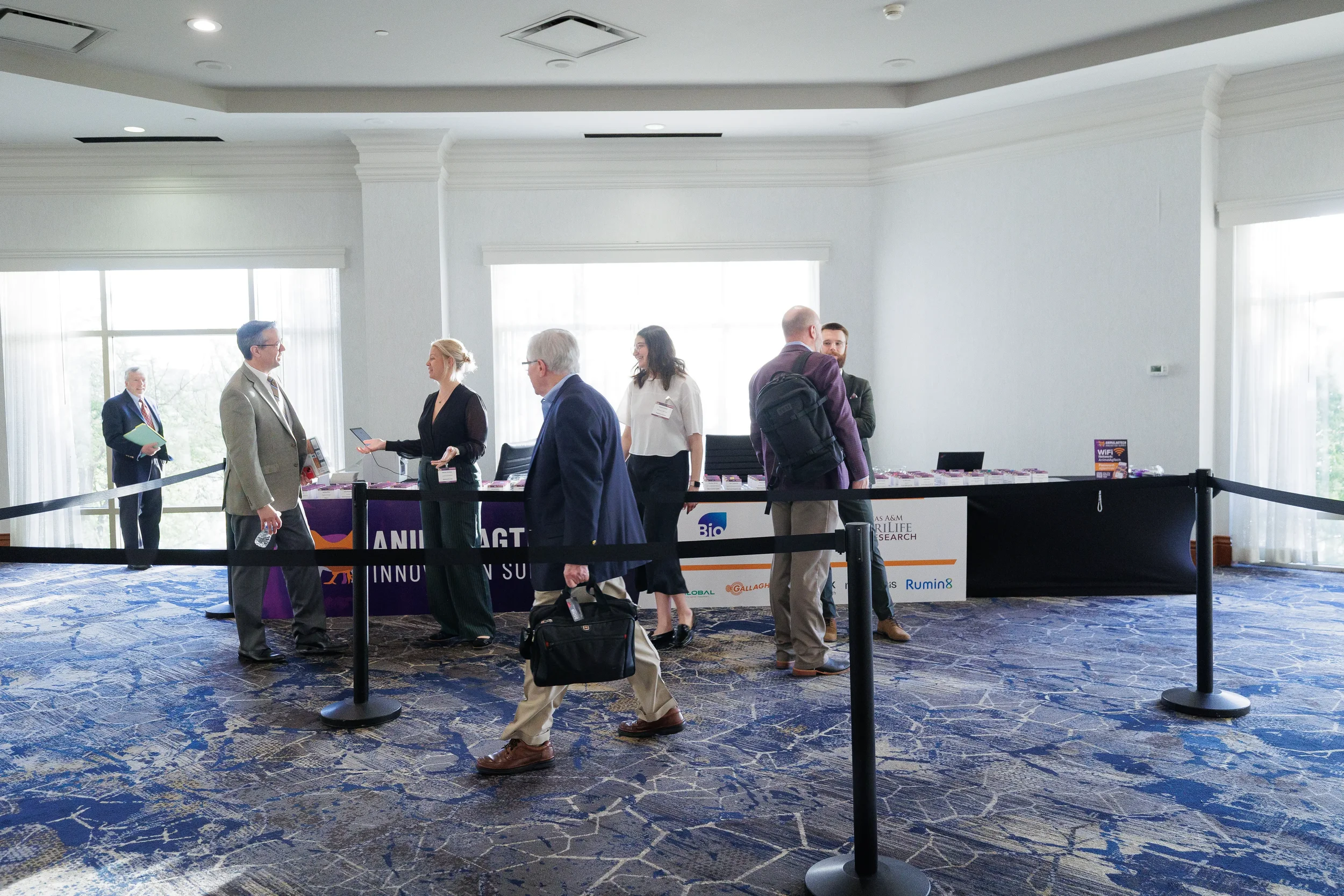Attendees gather near registration area during check-in at Orlando industry conference