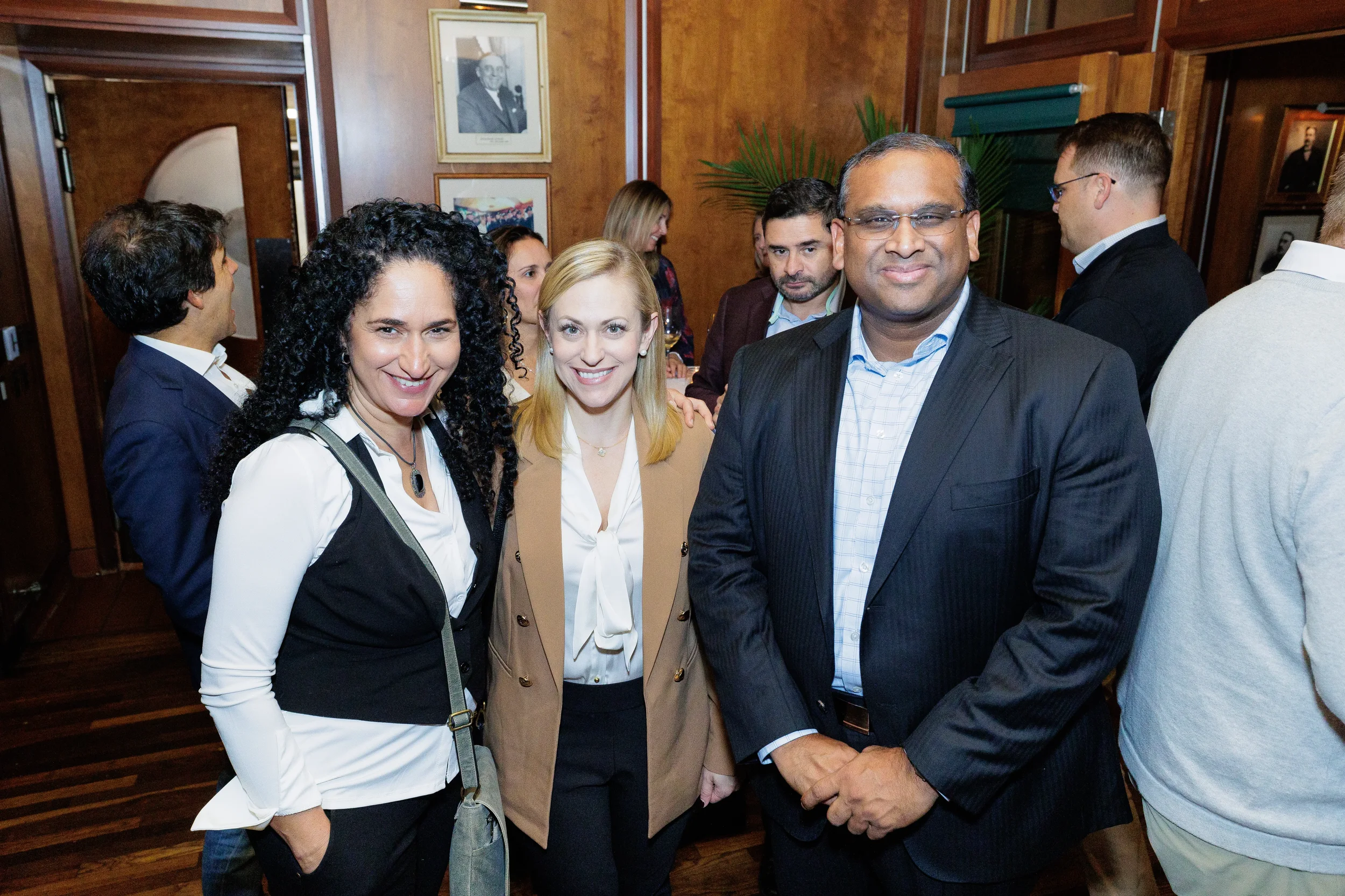 Three conference attendees pose for a photo during networking reception at Chicago corporate event