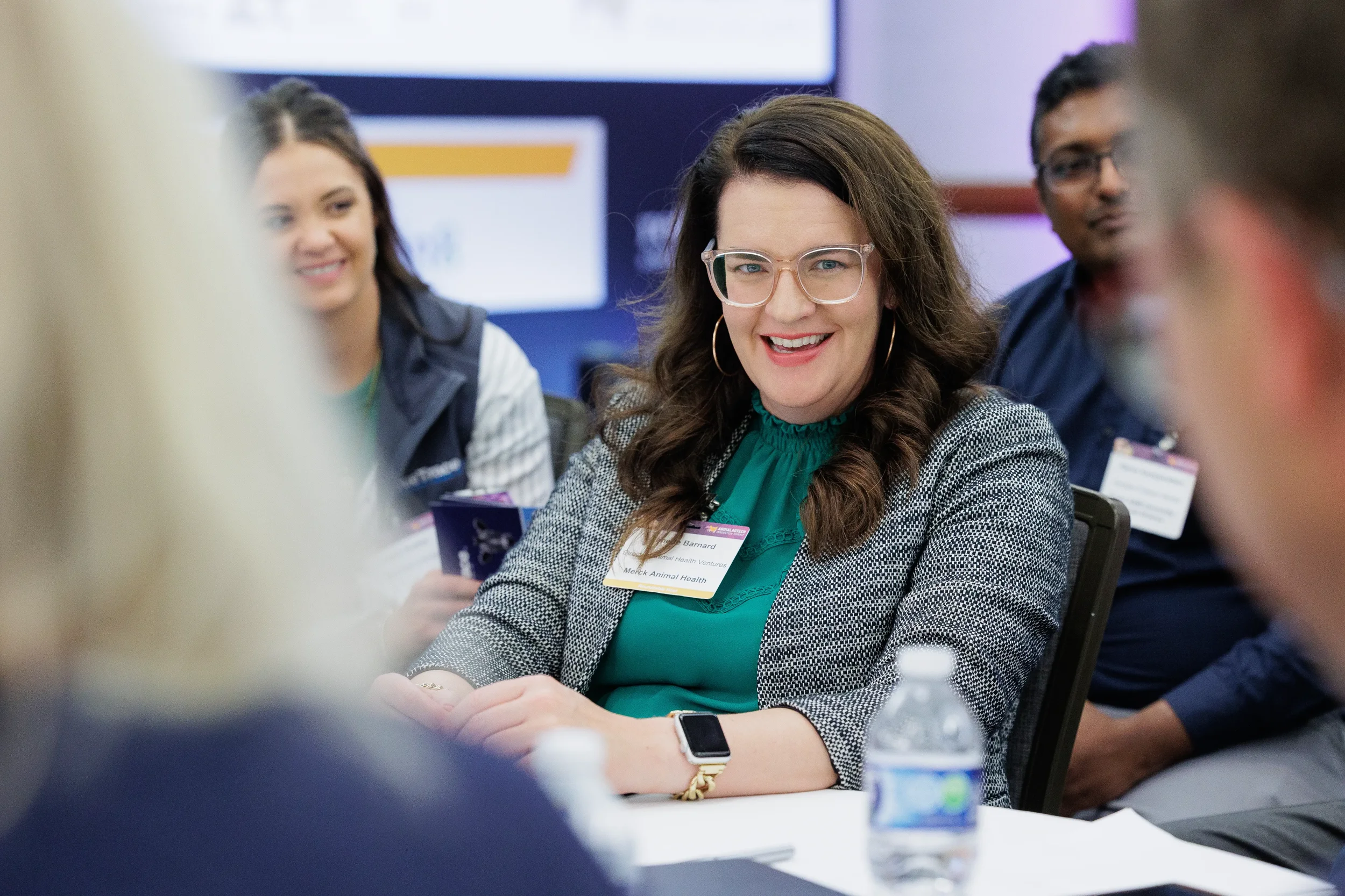 Attendee smiles during roundtable breakout session at Chicago corporate networking event