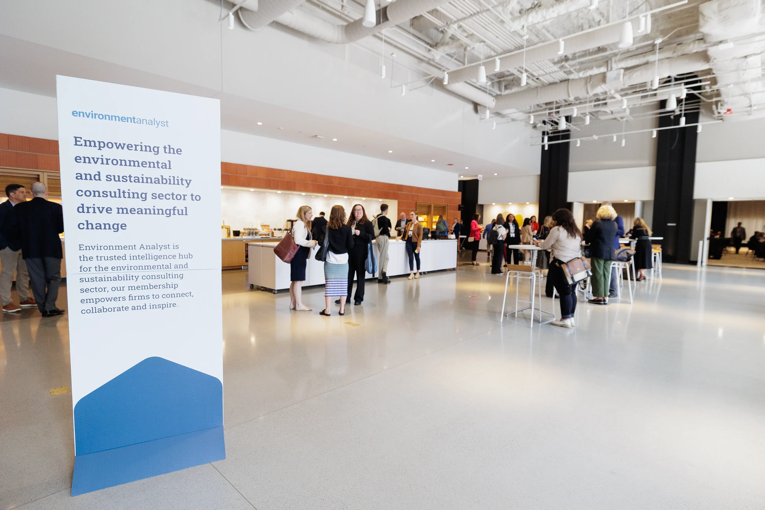 Attendees network in lobby space during break at Chicago corporate conference event