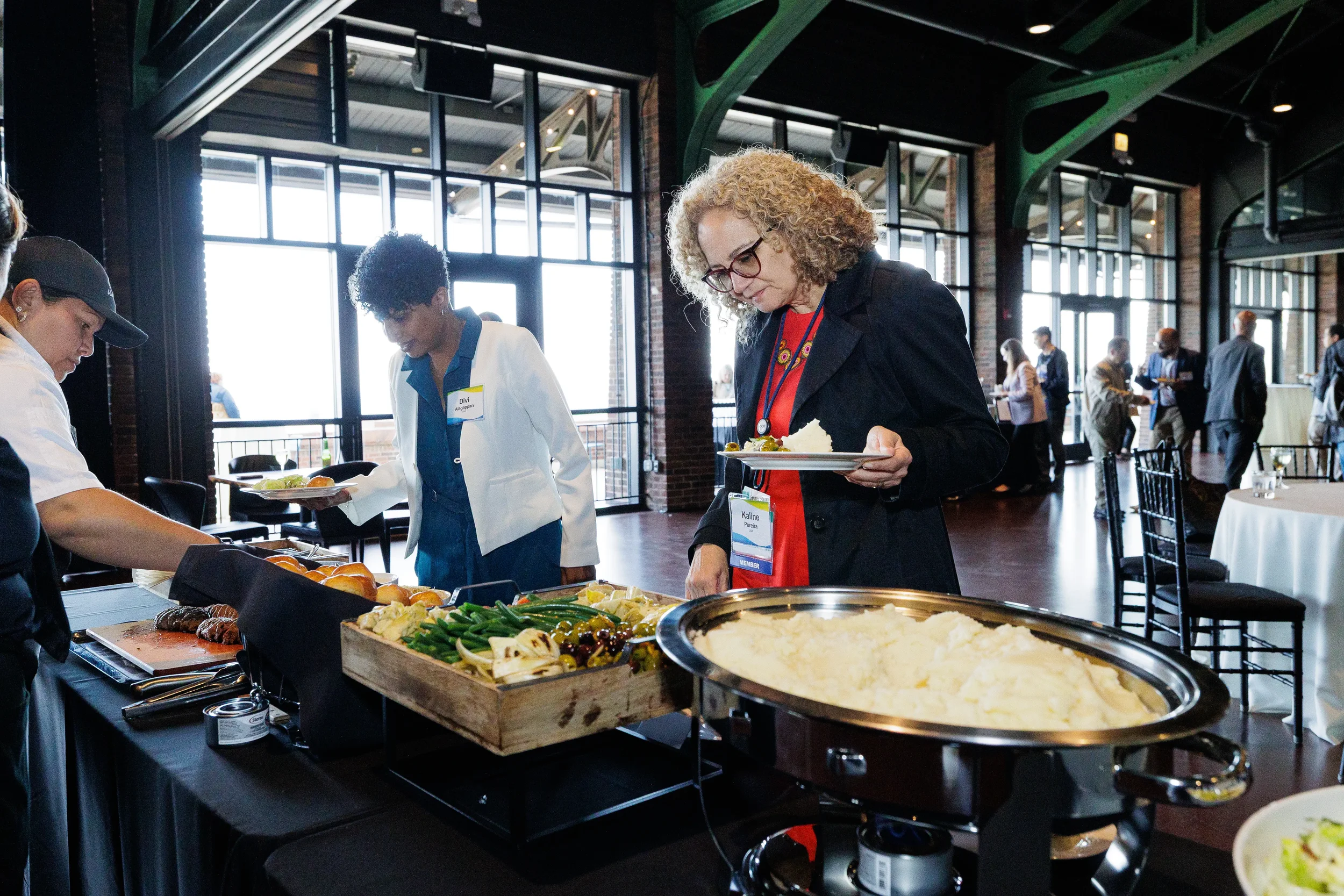 Attendees serve themselves at buffet during Orlando networking reception