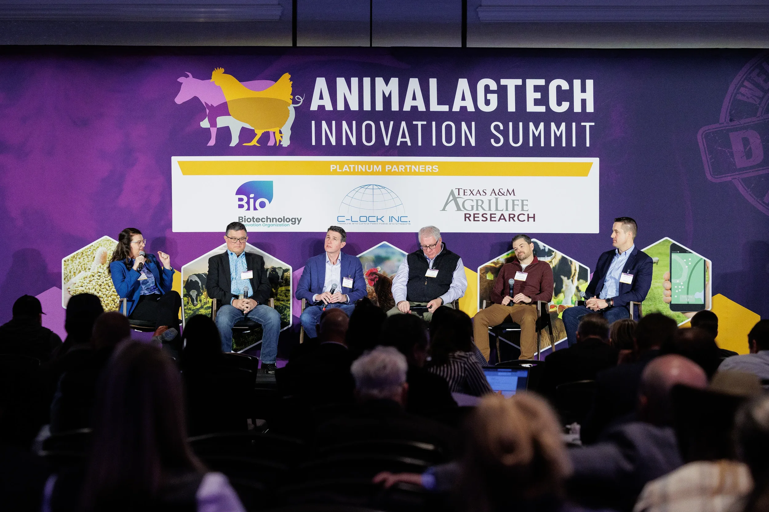 Six panelists seated on stage before full event banner at Orlando corporate summit