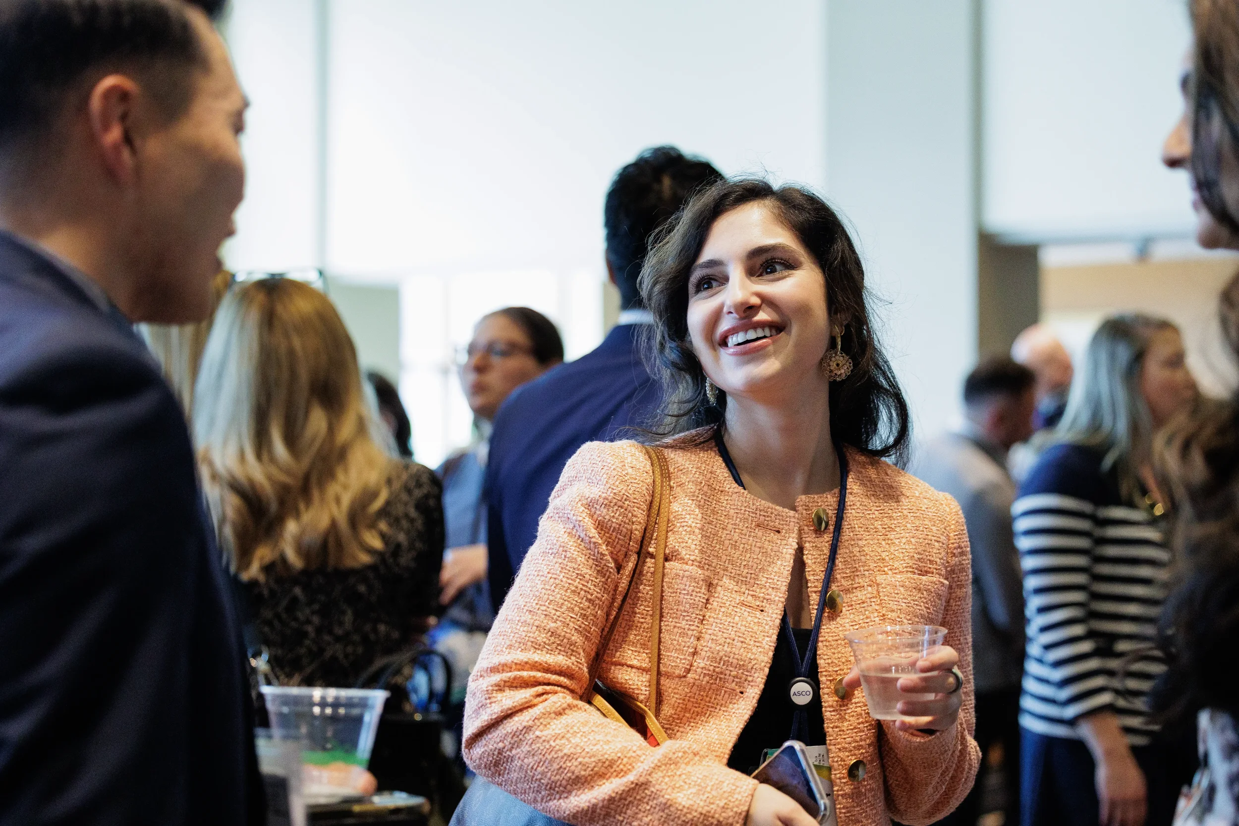 Attendee smiles during conversation at Chicago corporate conference reception