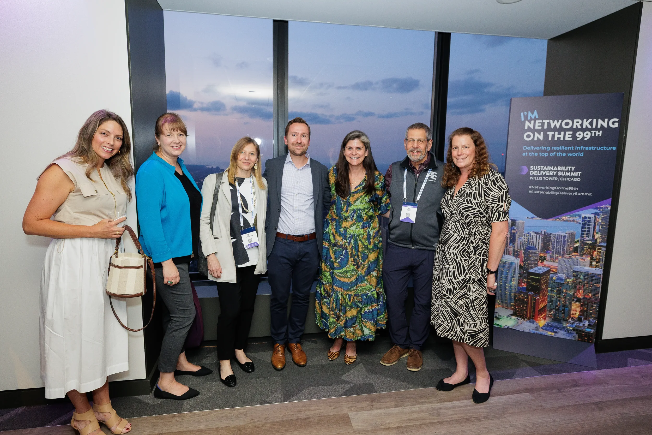 Group poses together with skyline view during evening Chicago corporate event reception