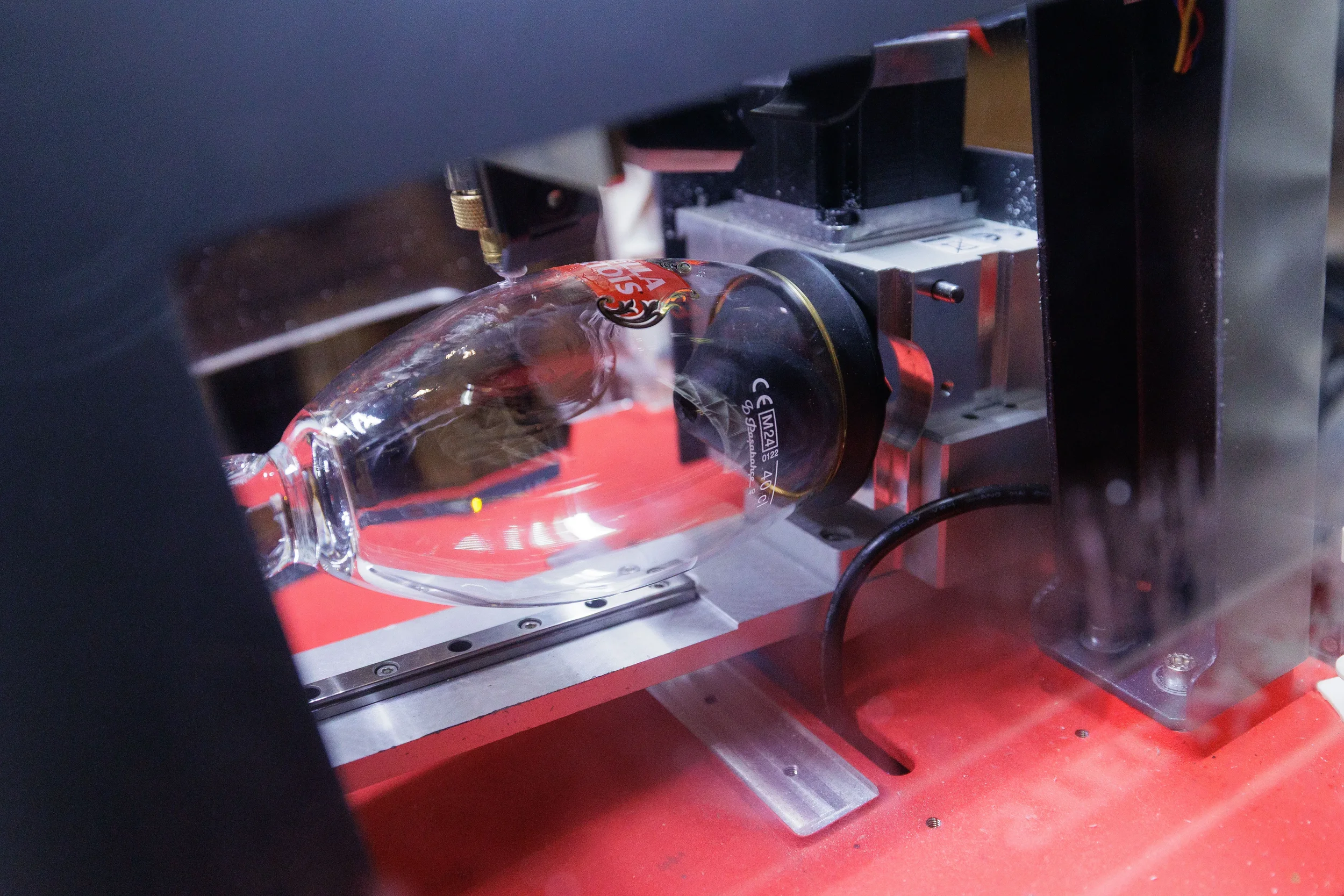 Laser engraver etches custom design onto wine glass at sponsor booth during Chicago corporate event