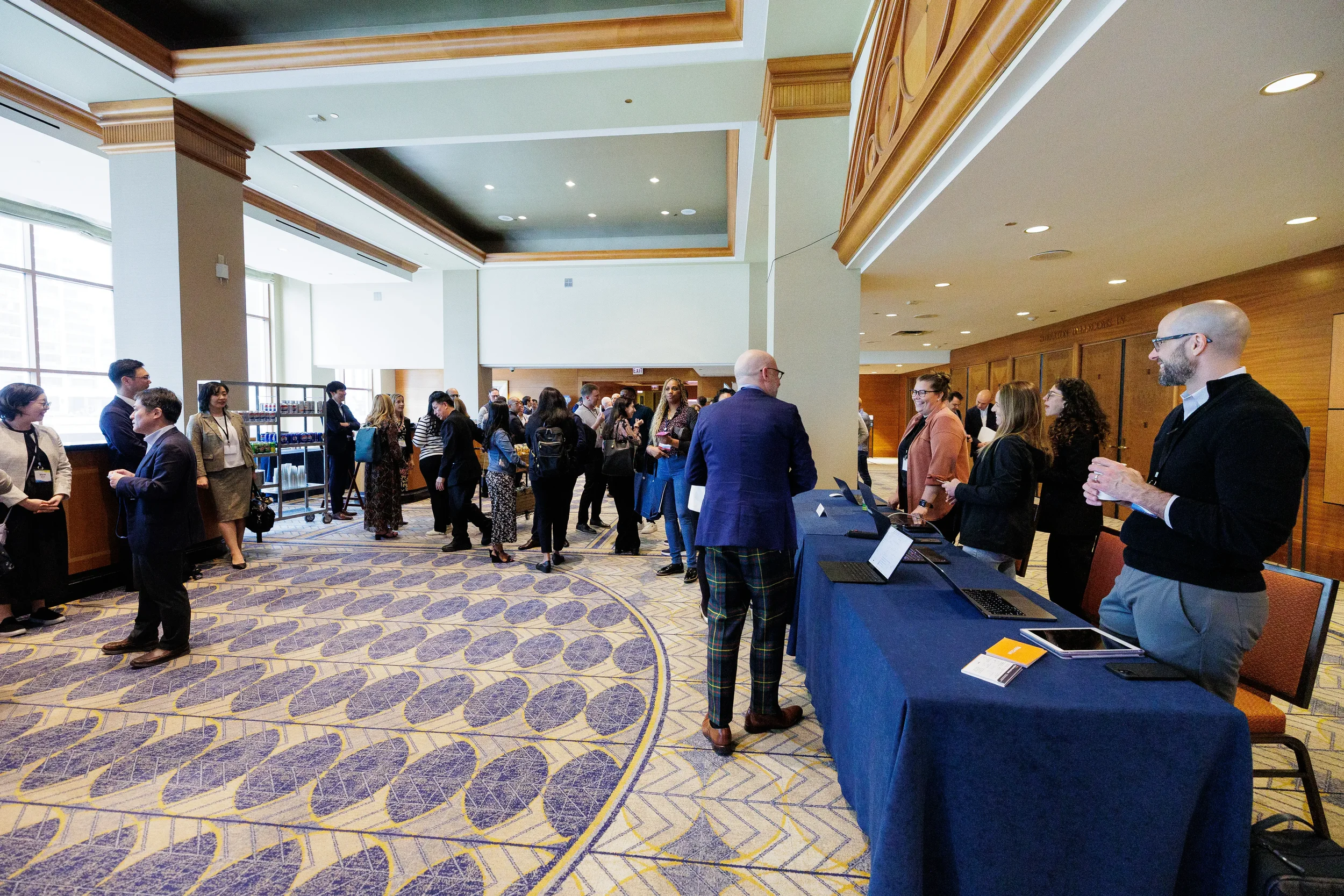 Attendees network near registration area at Orlando corporate conference