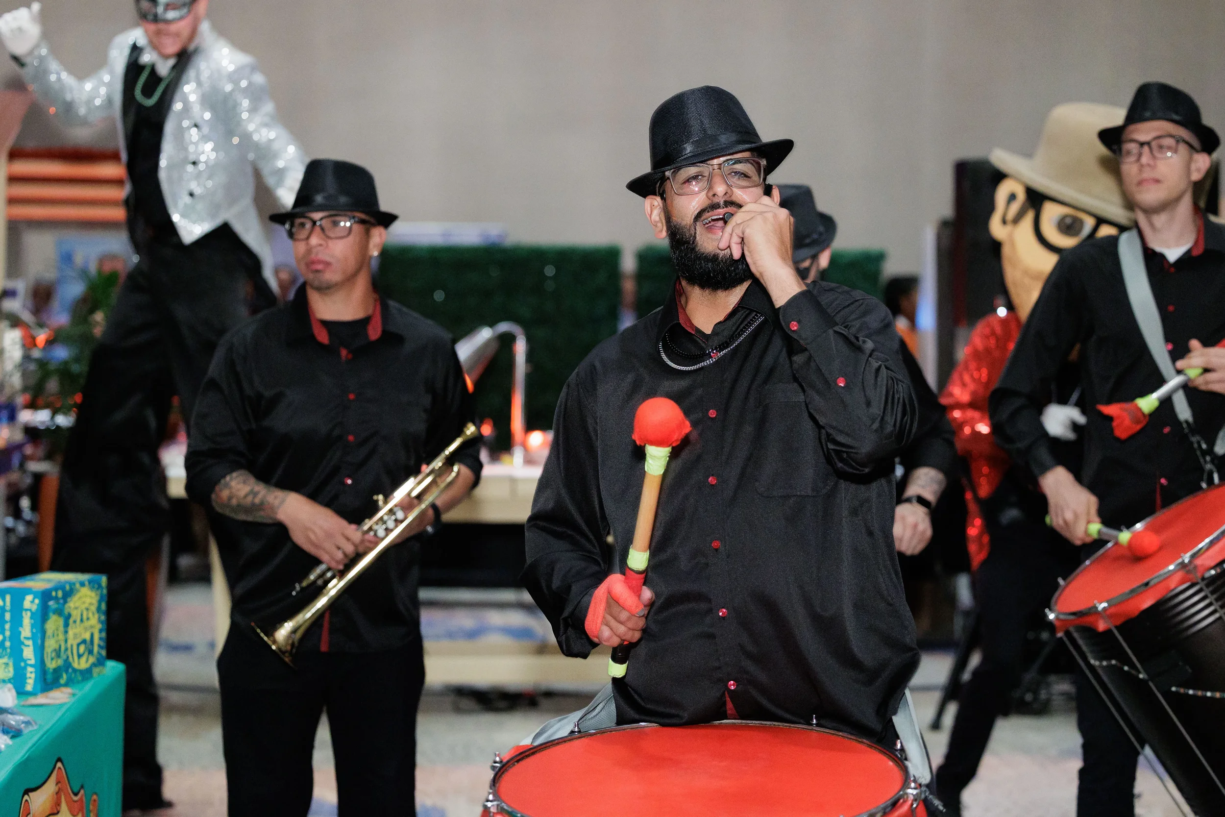 Live band drummer and vocalist perform in matching black outfits at Chicago corporate conference expo reception