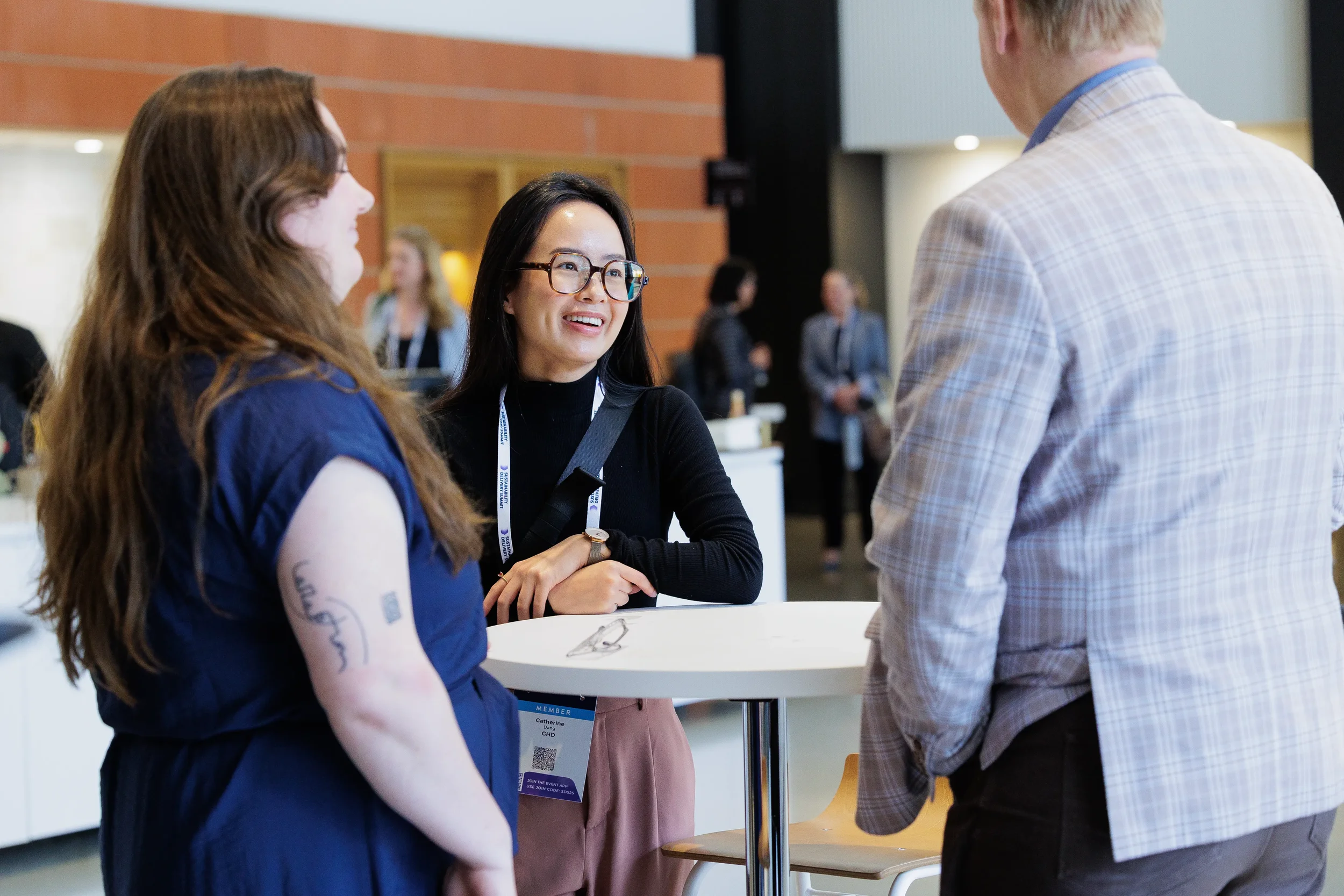 Attendees network at standing table during break at Chicago industry conference